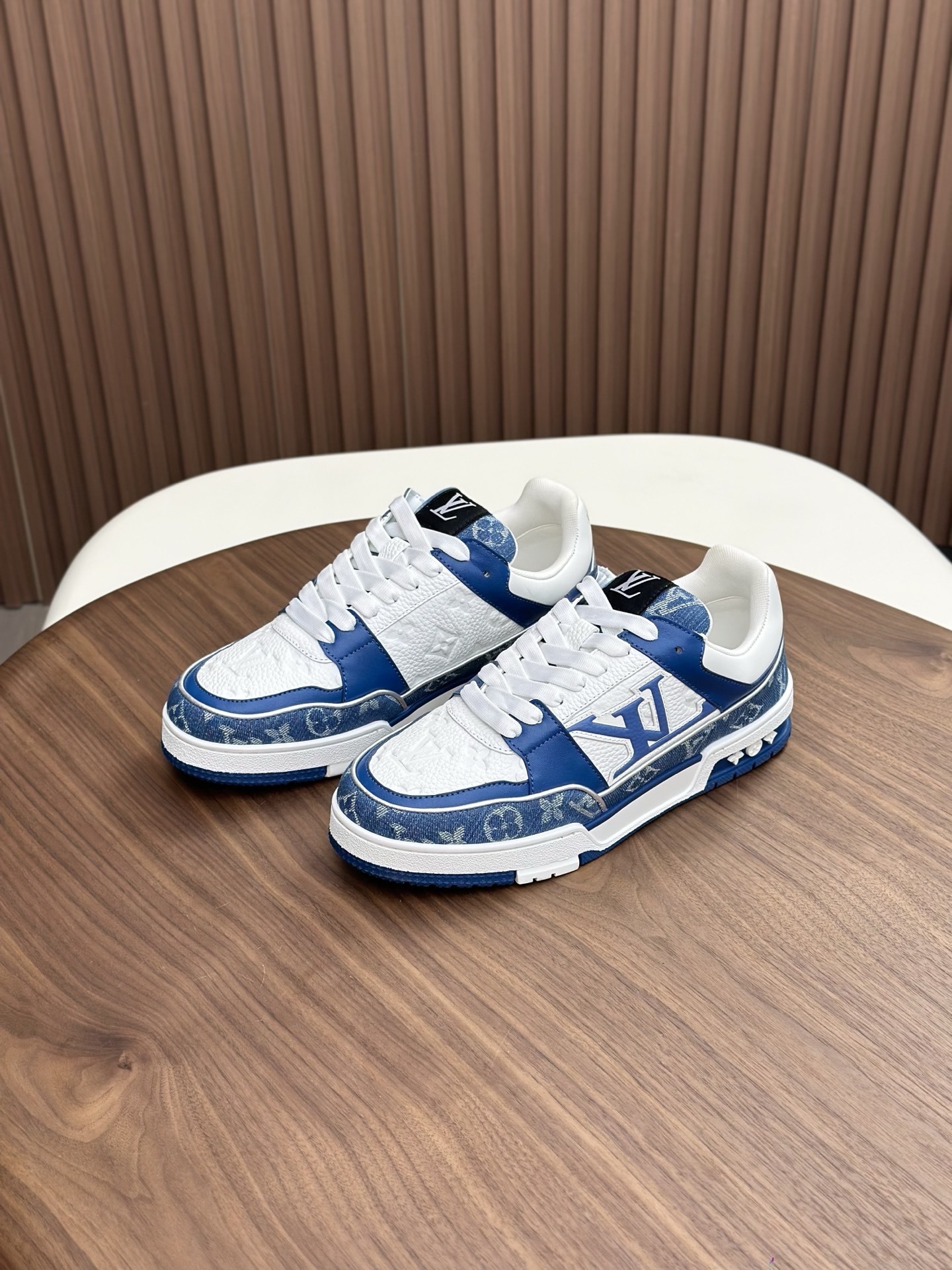 LV Trainer sneaker in the blue and white Monogram denim and Monogram-embossed grained calf leather.