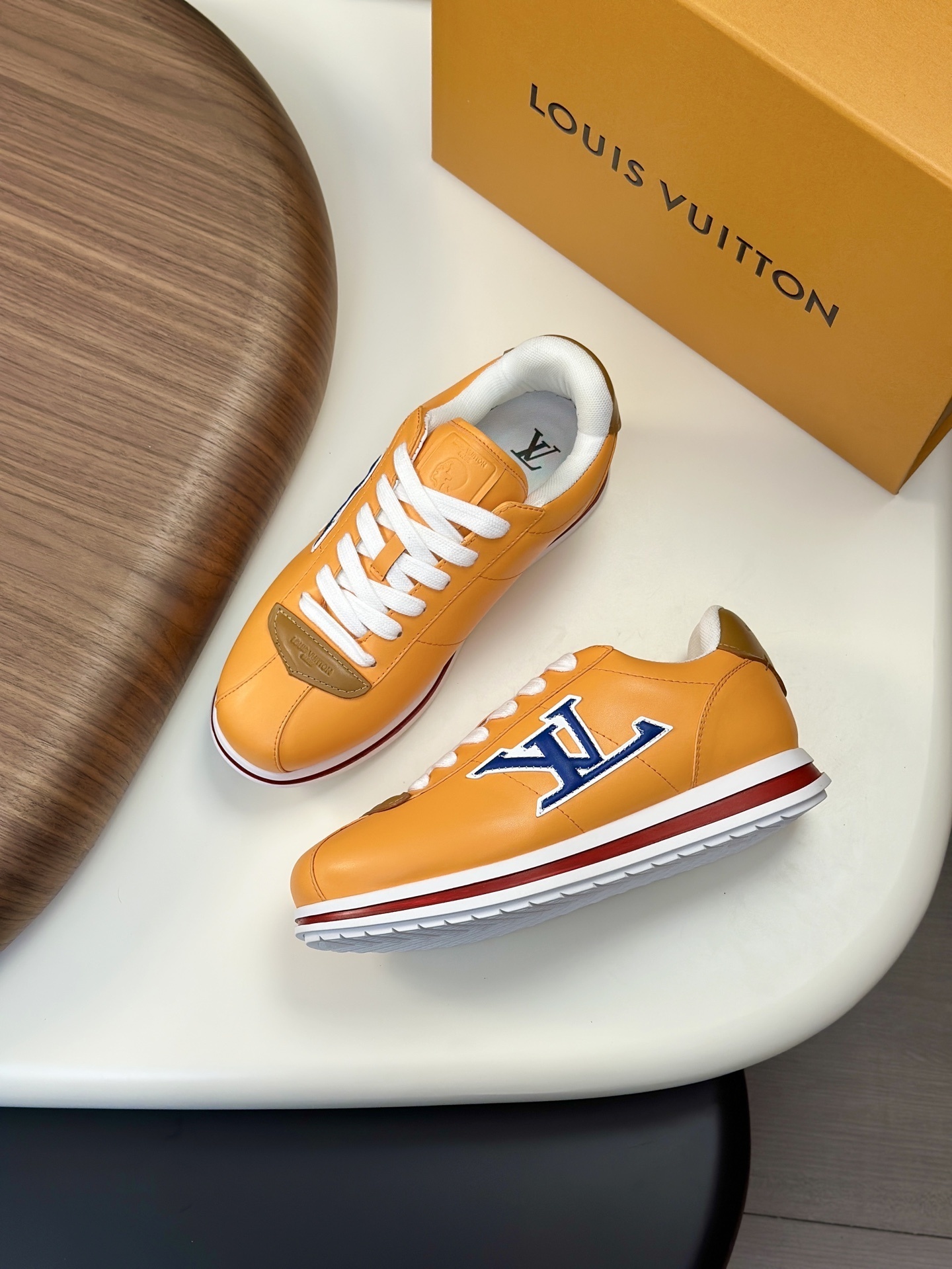 LV Buttersoft sneakers in orange lambskin and calf leather.