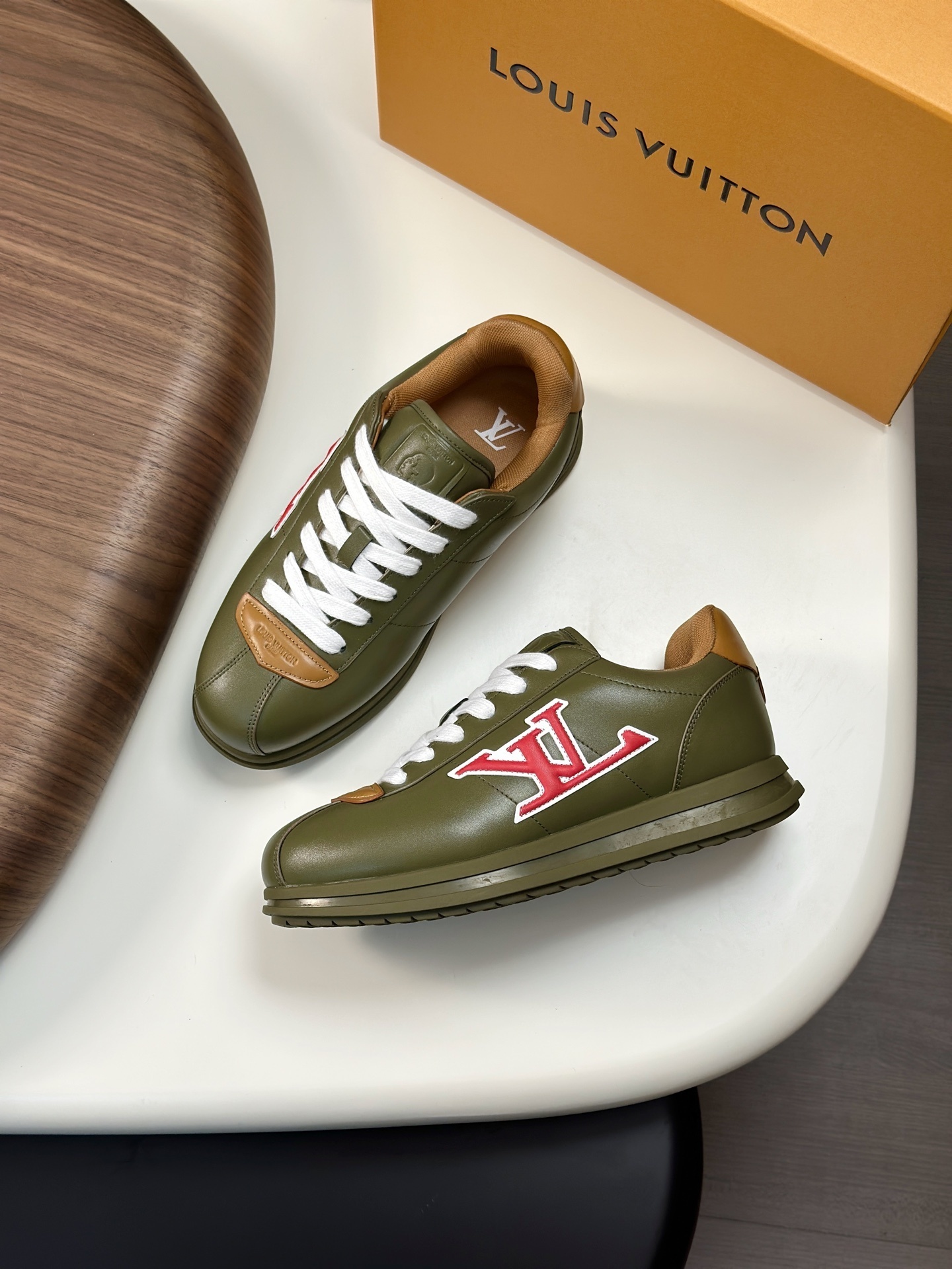 LV Buttersoft Sneakers in a green colorway with red and natural leather accents