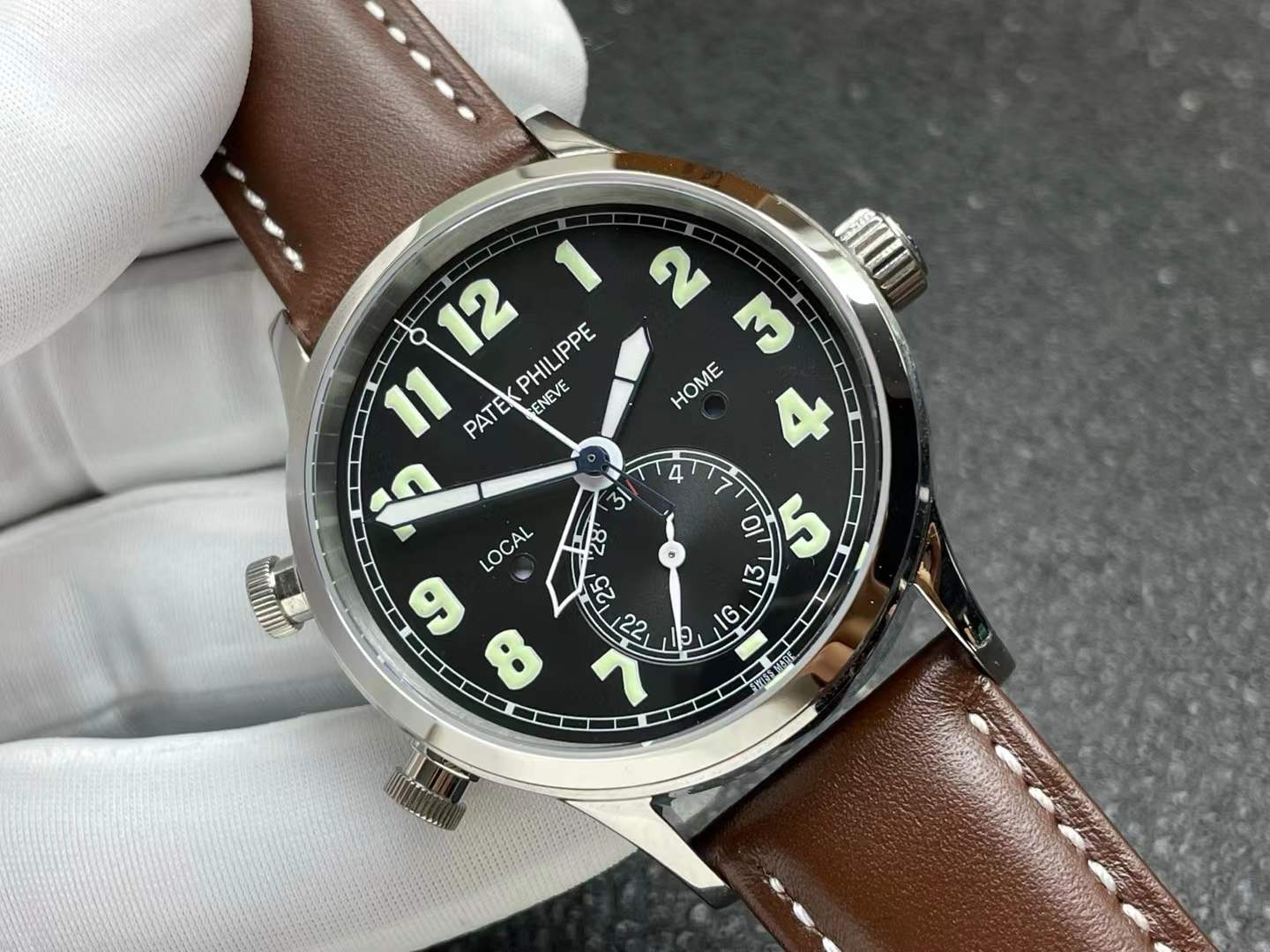 Patek Philippe Calatrava Pilot Travel Time watch with a black dial and a brown calfskin strap