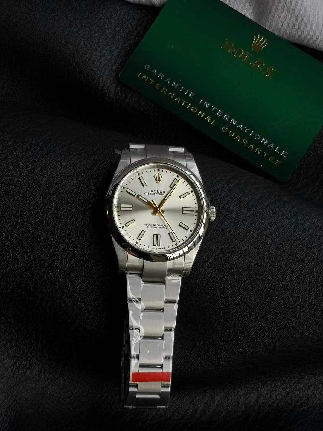 Rolex Oyster Perpetual 124300 watch in stainless steel with a silver dial and gold luminous stick markers