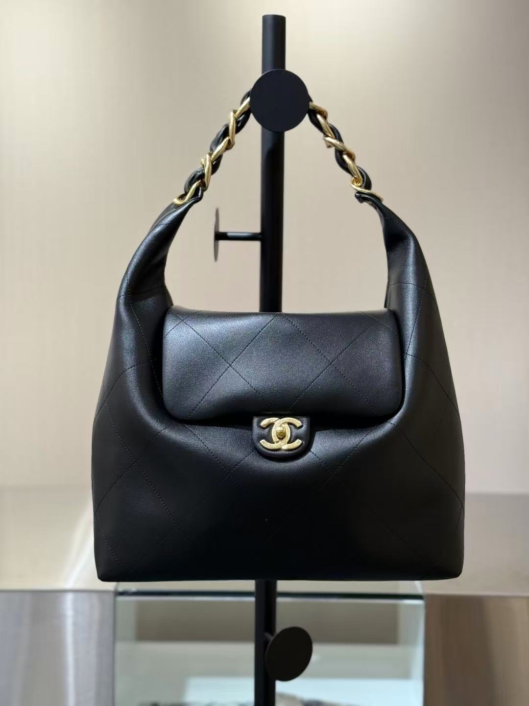 Chanel Maxi Hobo bag in black shiny lambskin leather with gold-tone metal hardware