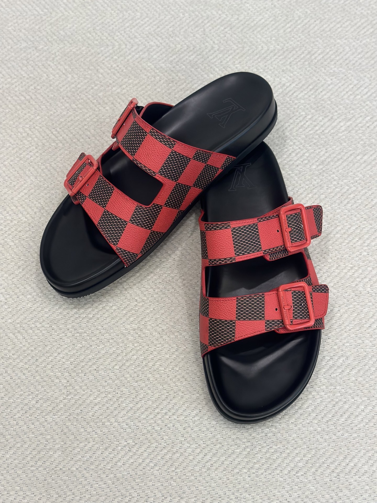 LV Sunset Flat Comfort Sandal in the red and black Damier pattern
