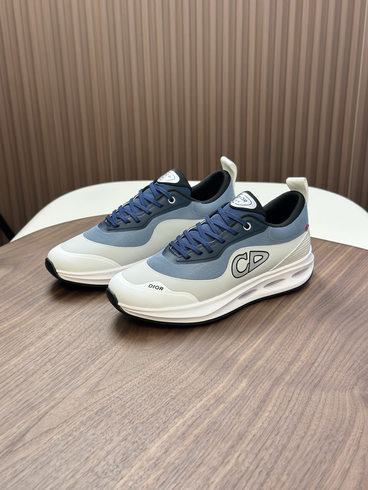 Dior blue and white sneakers with a "CD" logo on the side
