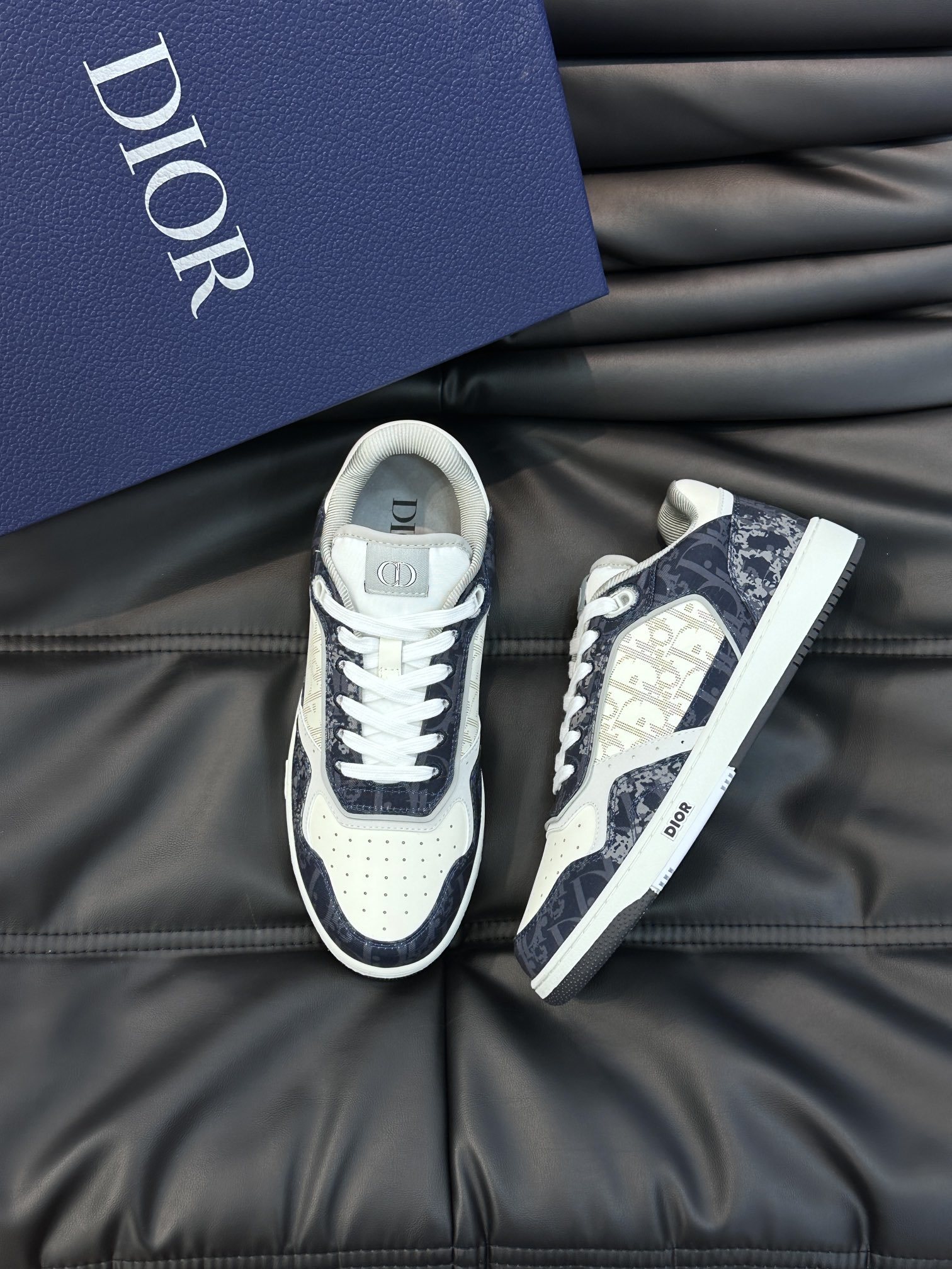 Dior B27 low-top sneaker in white smooth calfskin and blue denim with white Dior Oblique Galaxy leather inserts.