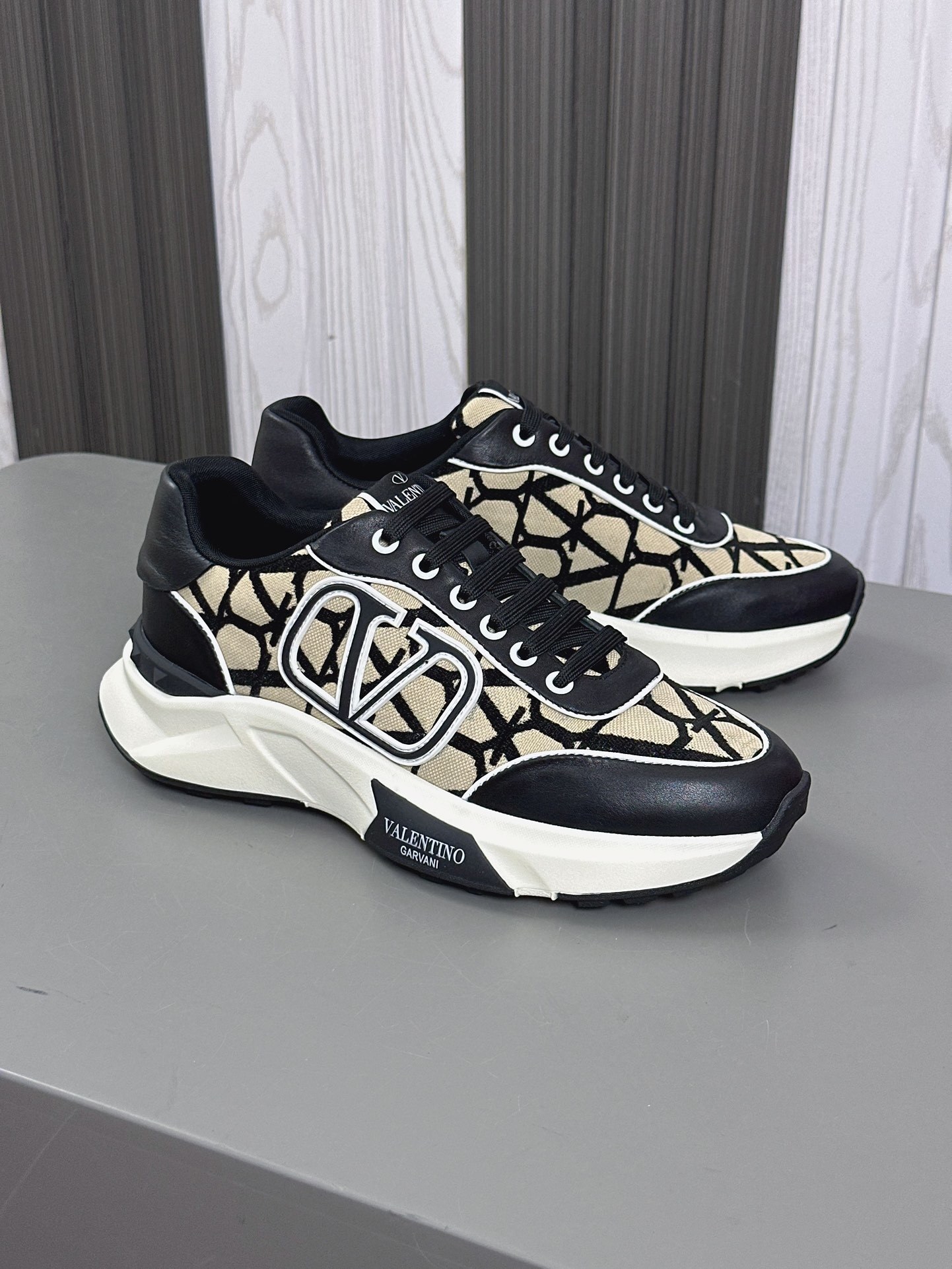 Valentino Garavani True Act low-top sneaker in mesh and rubberized fabric with a black and beige/white pattern