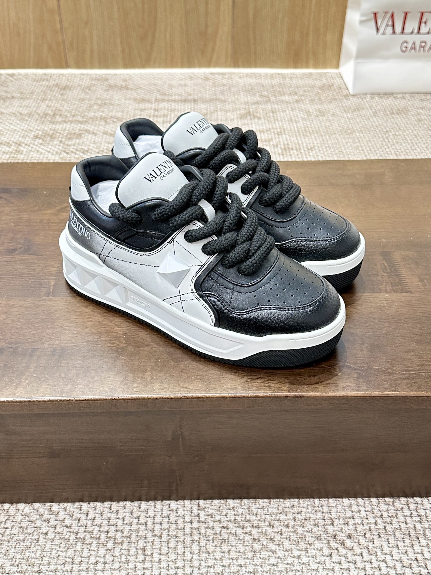 Valentino Garavani One Stud XL sneakers in two-tone nappa and perforated leather with black and white coloring