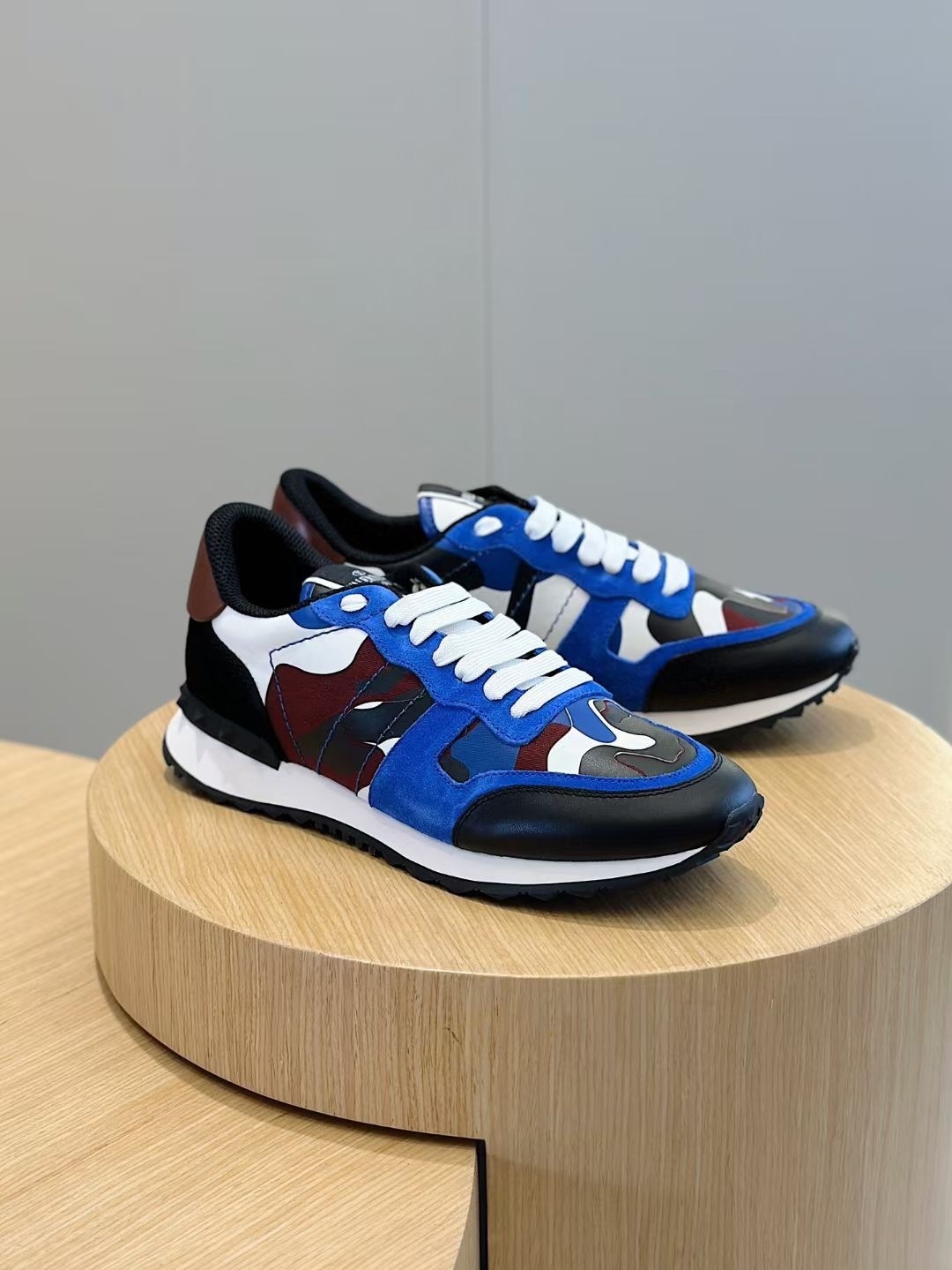 Valentino Garavani Rockrunner sneakers with a blue, black, white, and burgundy camouflage print