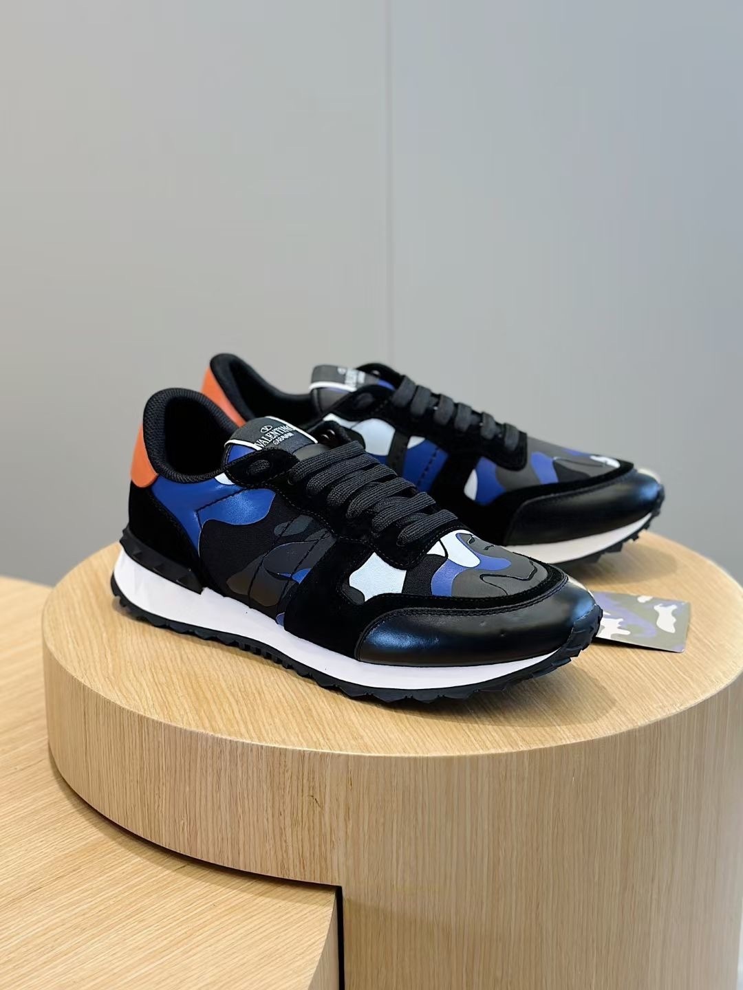 Valentino Garavani Rockrunner camouflage sneakers in blue, black, and orange with leather