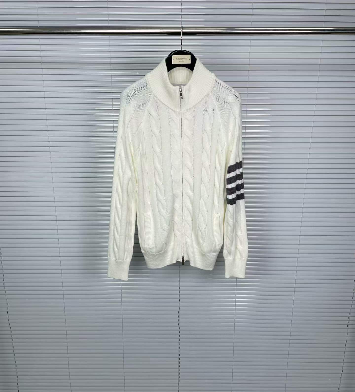 Thom Browne 4-Bar stripe white cable-knit zip-up cardigan.