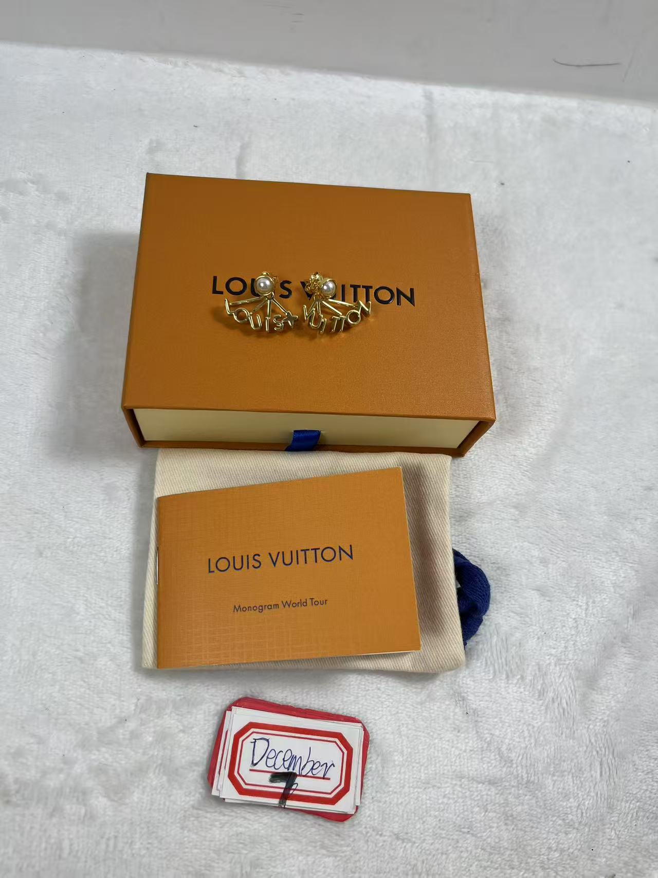 LV gold-tone stud earrings with pearl accents