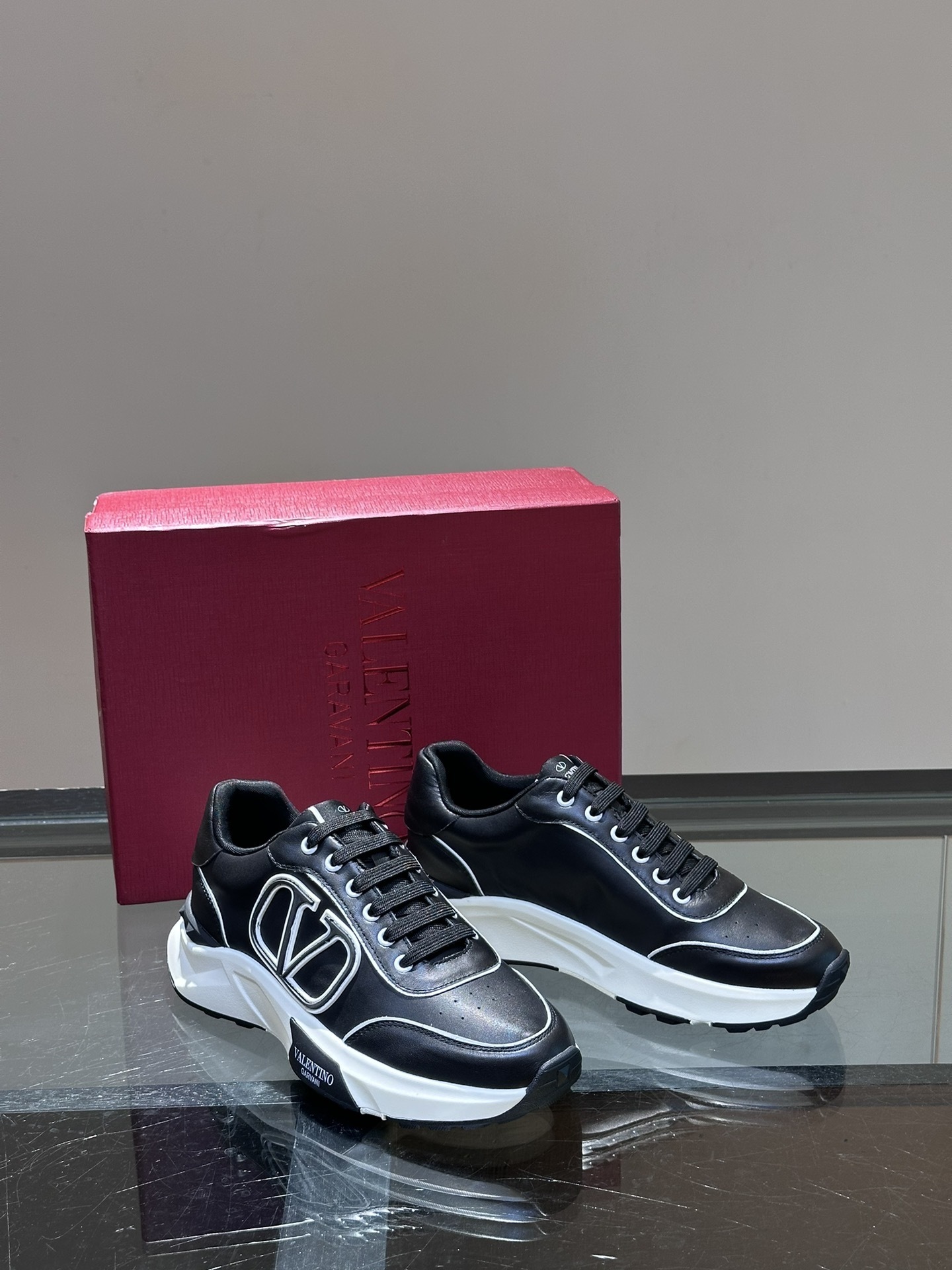 Valentino Garavani VL7N low-top sneaker in black calf leather with white details and a rubber sole.