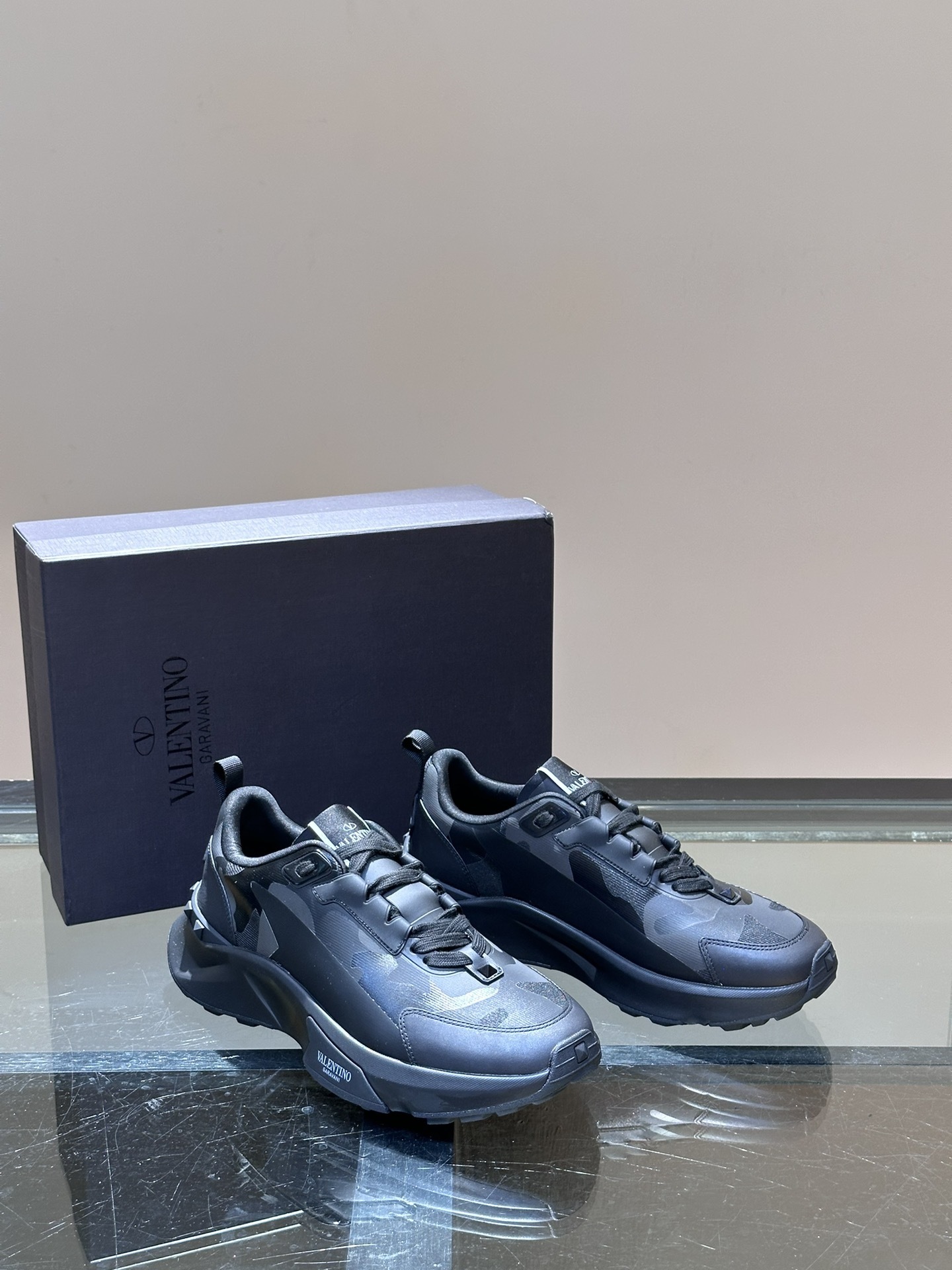 Valentino Yeezy Boost 700 MNVN sneaker in the "Triple Black" colorway