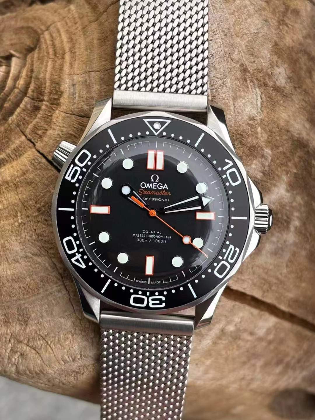 Omega Seamaster Diver 300M Co-Axial Master Chronometer watch with a black dial and a mesh bracelet.