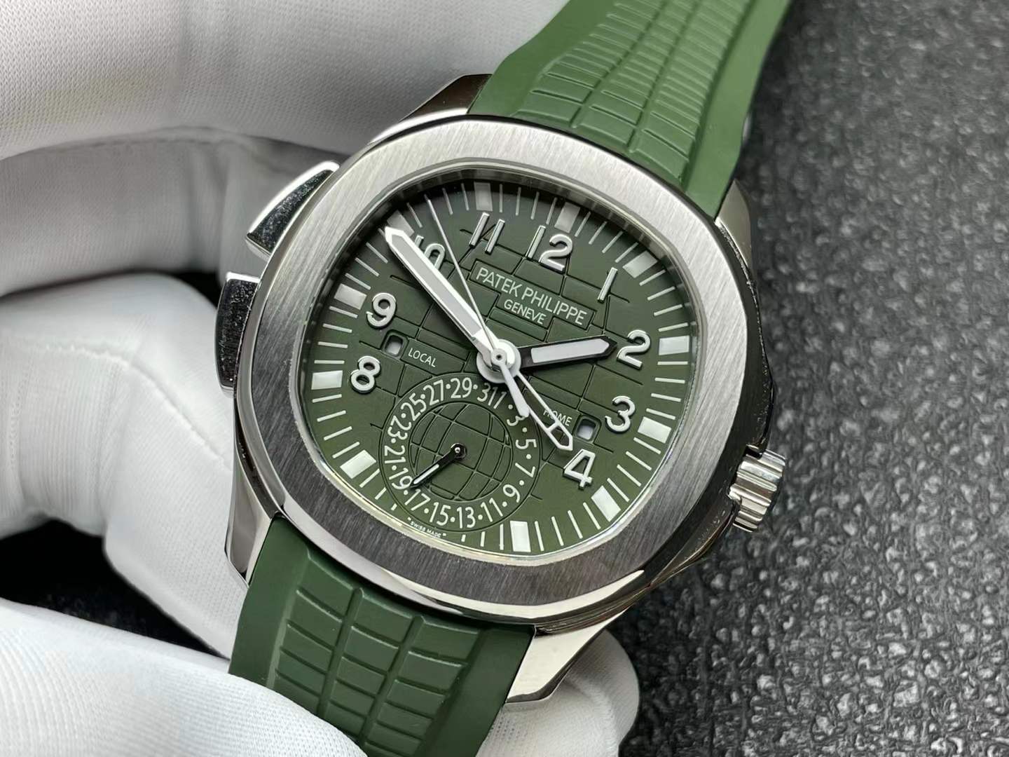 Patek Philippe Aquanaut Travel Time watch (Ref. 5164A) in stainless steel with an olive green dial and composite strap