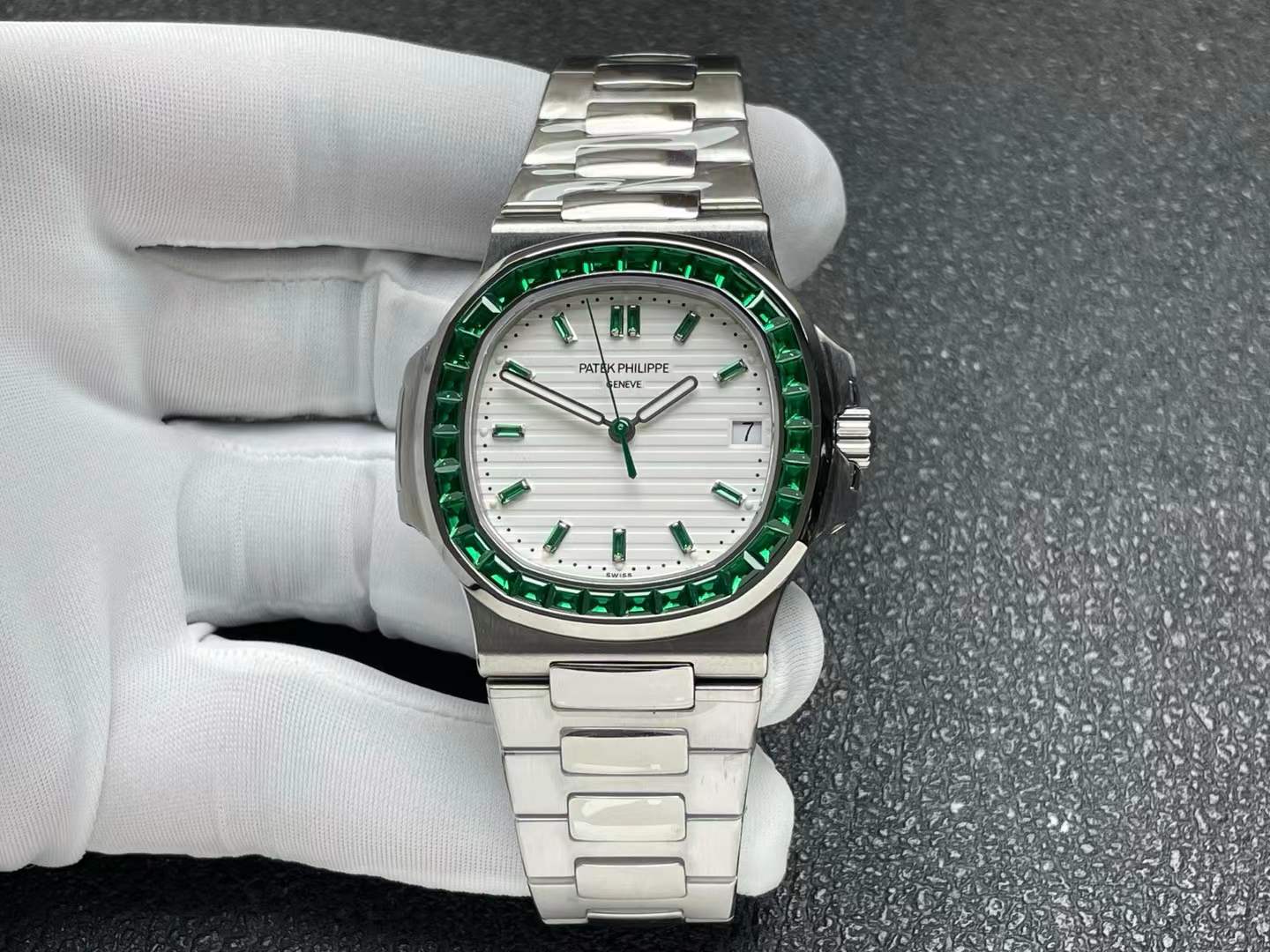 Patek Philippe Nautilus ref. 5711/113P-001 in platinum with a white dial and emerald-set bezel
