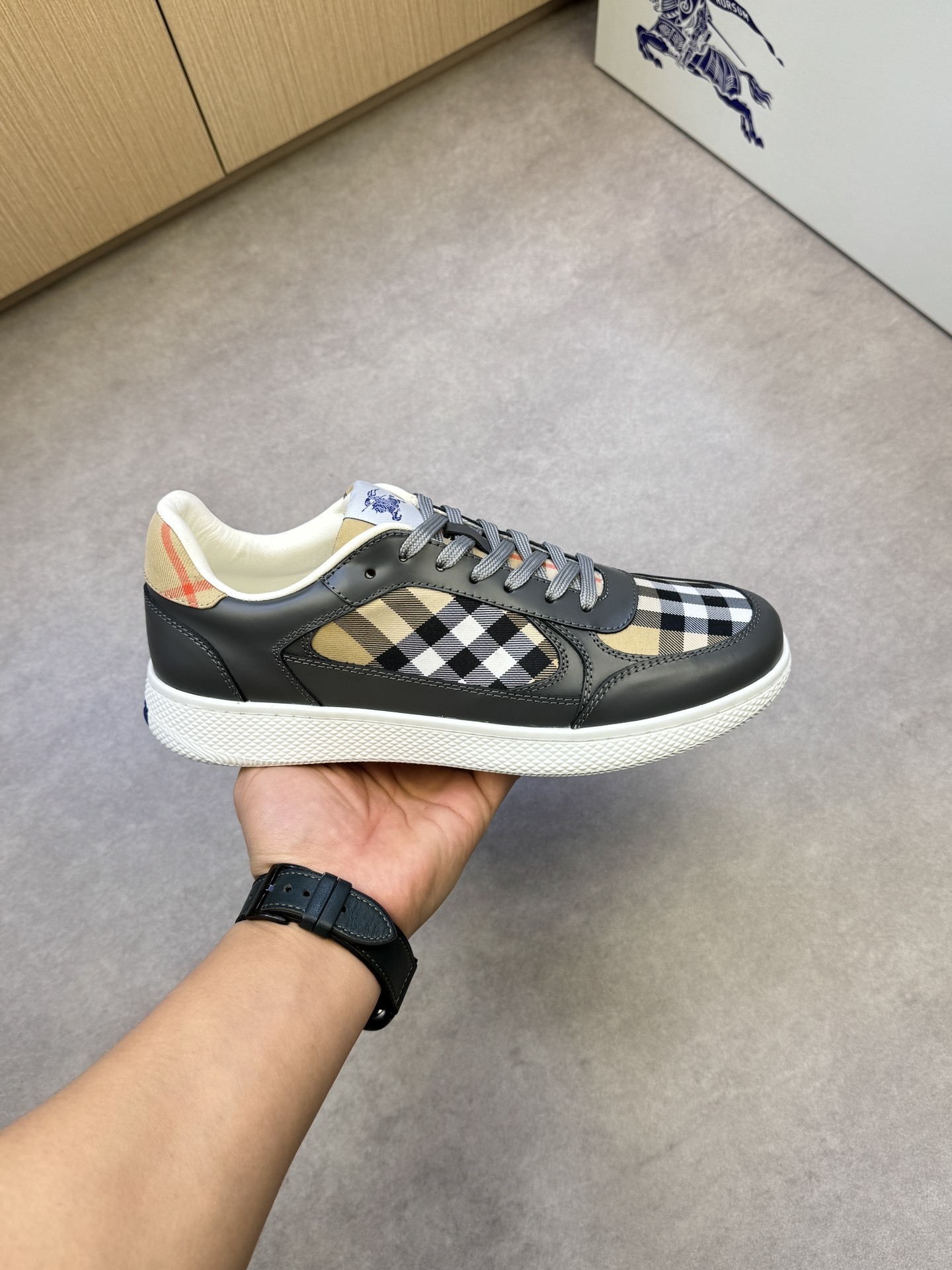 Burberry Terrace sneakers in black leather and the signature sand check pattern