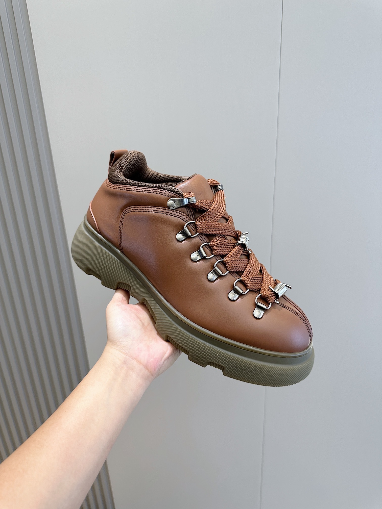 Burberry Trek leather hiking boots in a tan color chunky rubber sole and D-ring lace-up fastening