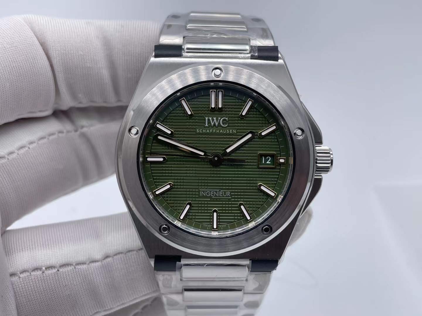 IWC Ingenieur Automatic 40 watch with a green "Grid" patterned dial and a stainless steel case and integrated bracelet
