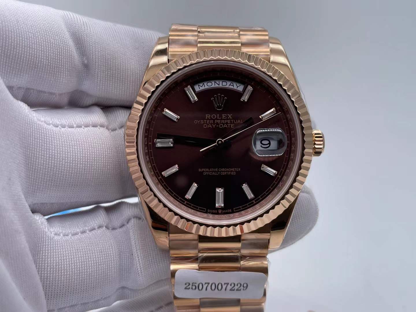 Oyster Perpetual Day-Date 40 with a chocolate dial rose gold case fluted bezel baguette diamond hour markers, and President bracelet