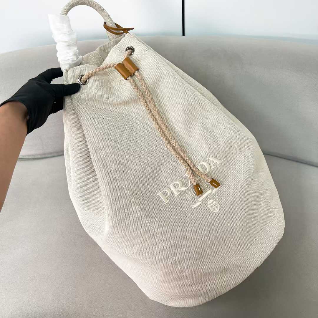 Prada Linen Blend Bucket Bag with leather trim and an embroidered logo