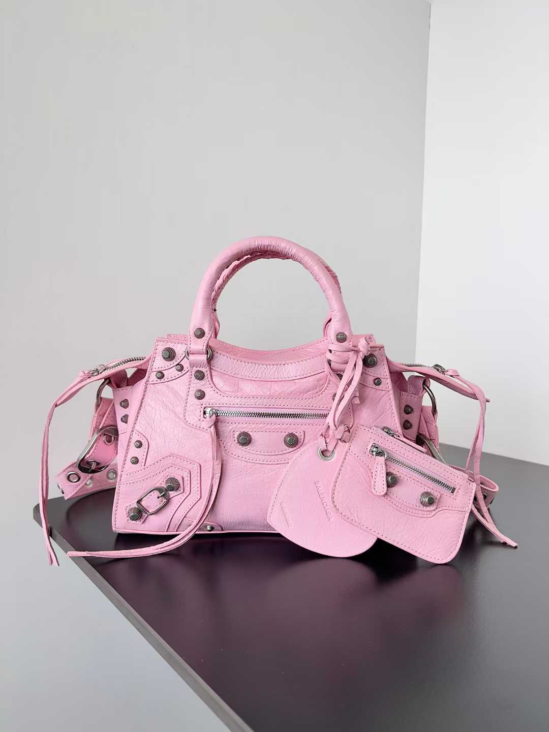 Balenciaga Neo Cagole XS handbag in powder pink Arena lambskin with aged-silver hardware.