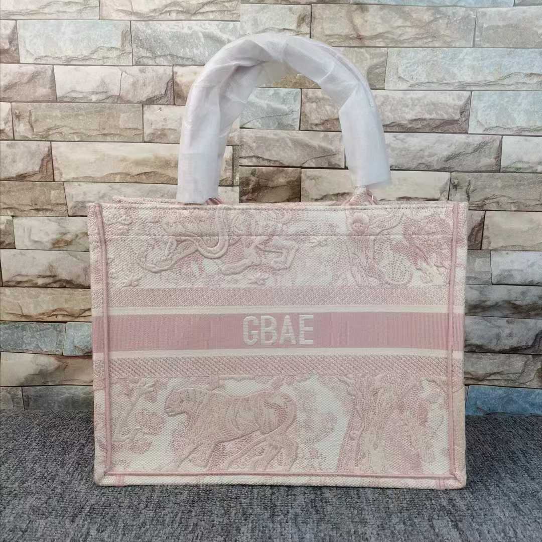 Dior Book Tote in ecru and pink with a Toile de Jouy motif embroidery