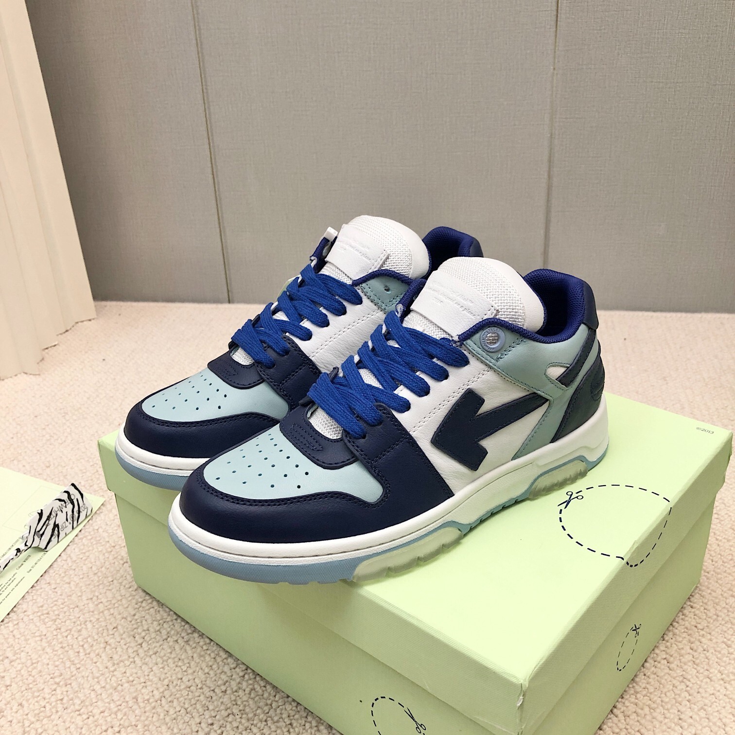 Off-White Out of Office "OOO" low-top sneakers in a white, navy, and light blue colorway