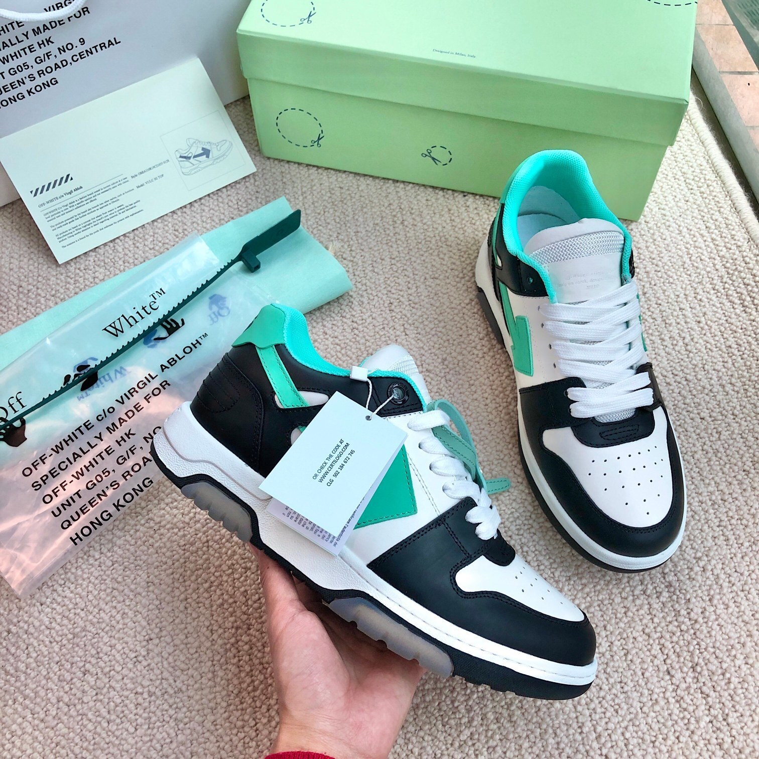 Off-White Out of Office sneaker in a black, white, and green