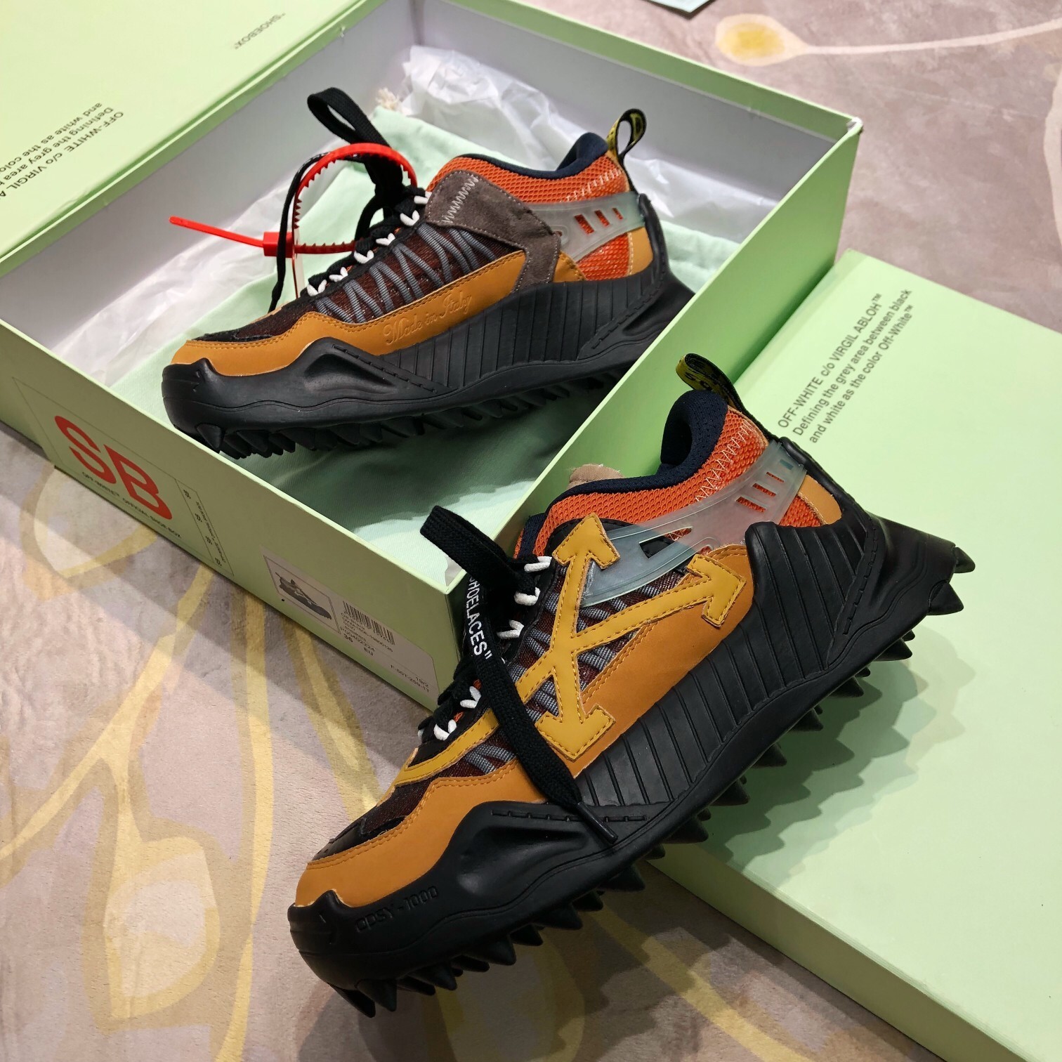 Off-White ODSY-1000 sneakers featuring a chunky design, a mix of materials, and signature branding details like the Zip Tie and Arrows motif.