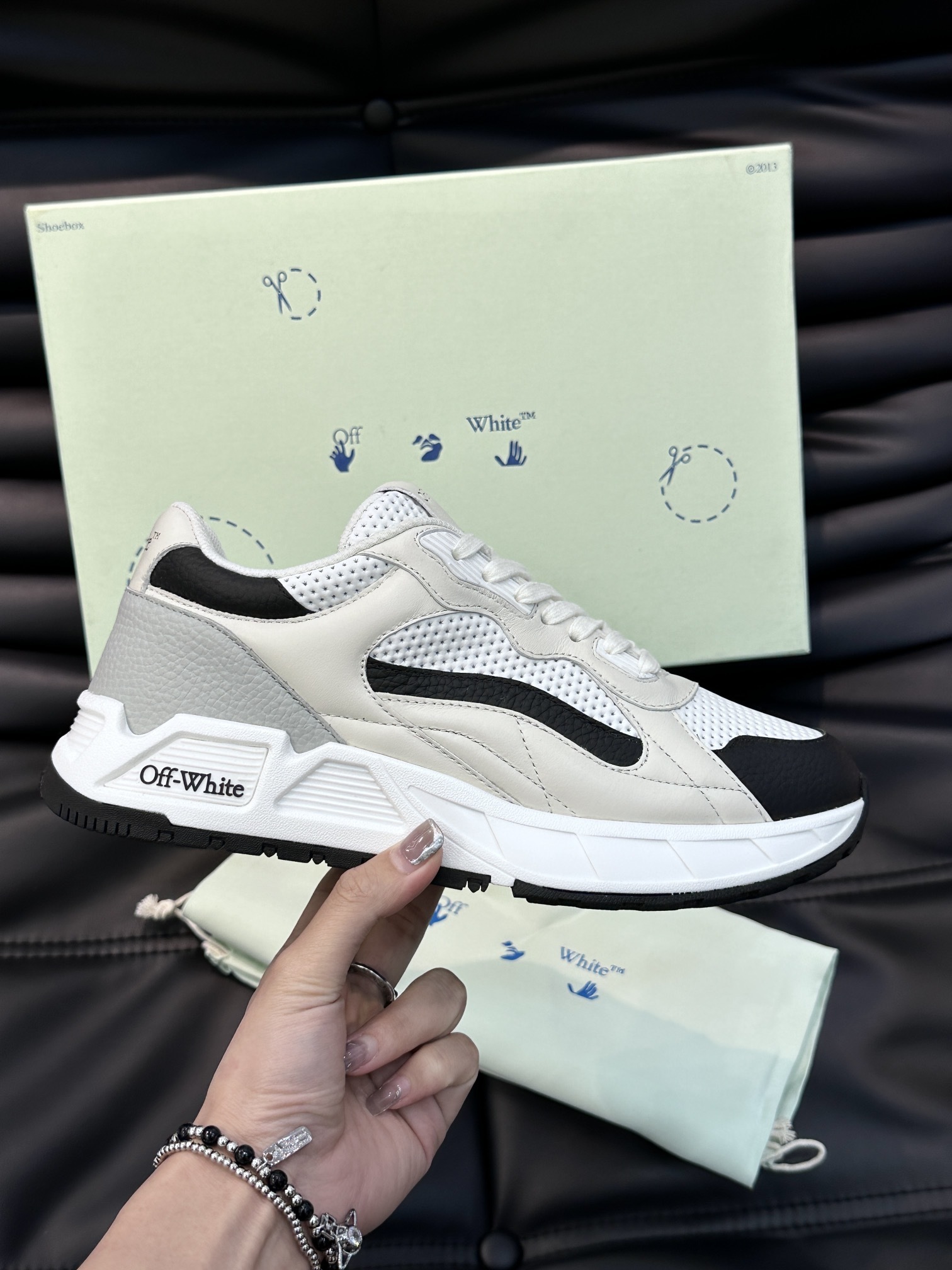 Off-White Kick Off leather sneakers featuring a white, black, and grey paneled design and a chunky rubber sole.