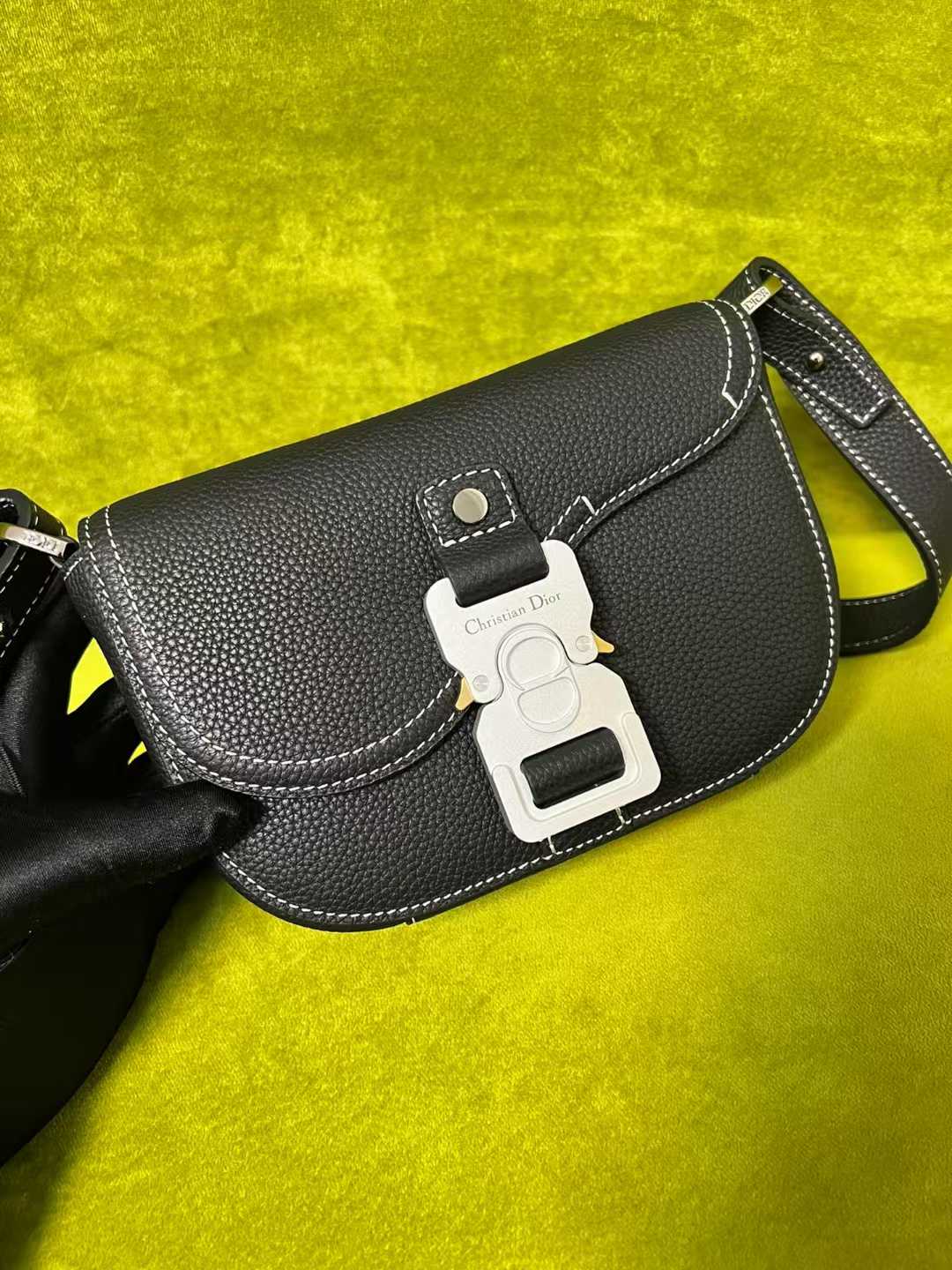 Dior Mini Saddle Messenger Bag with Flap in black grained calfskin leather with white topstitching and an aluminum buckle