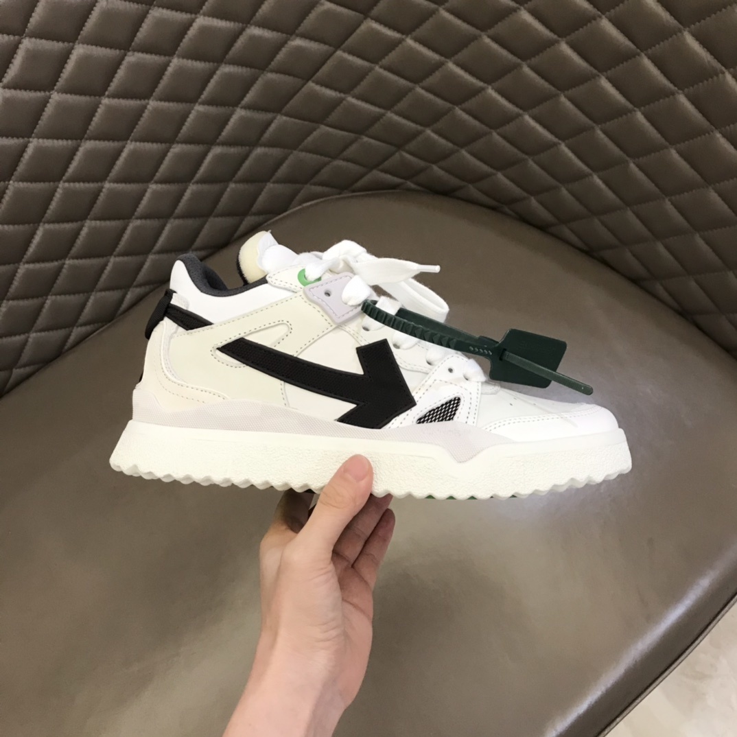Off-White Sponge Mid Top sneaker in white and black with a green zip tie
