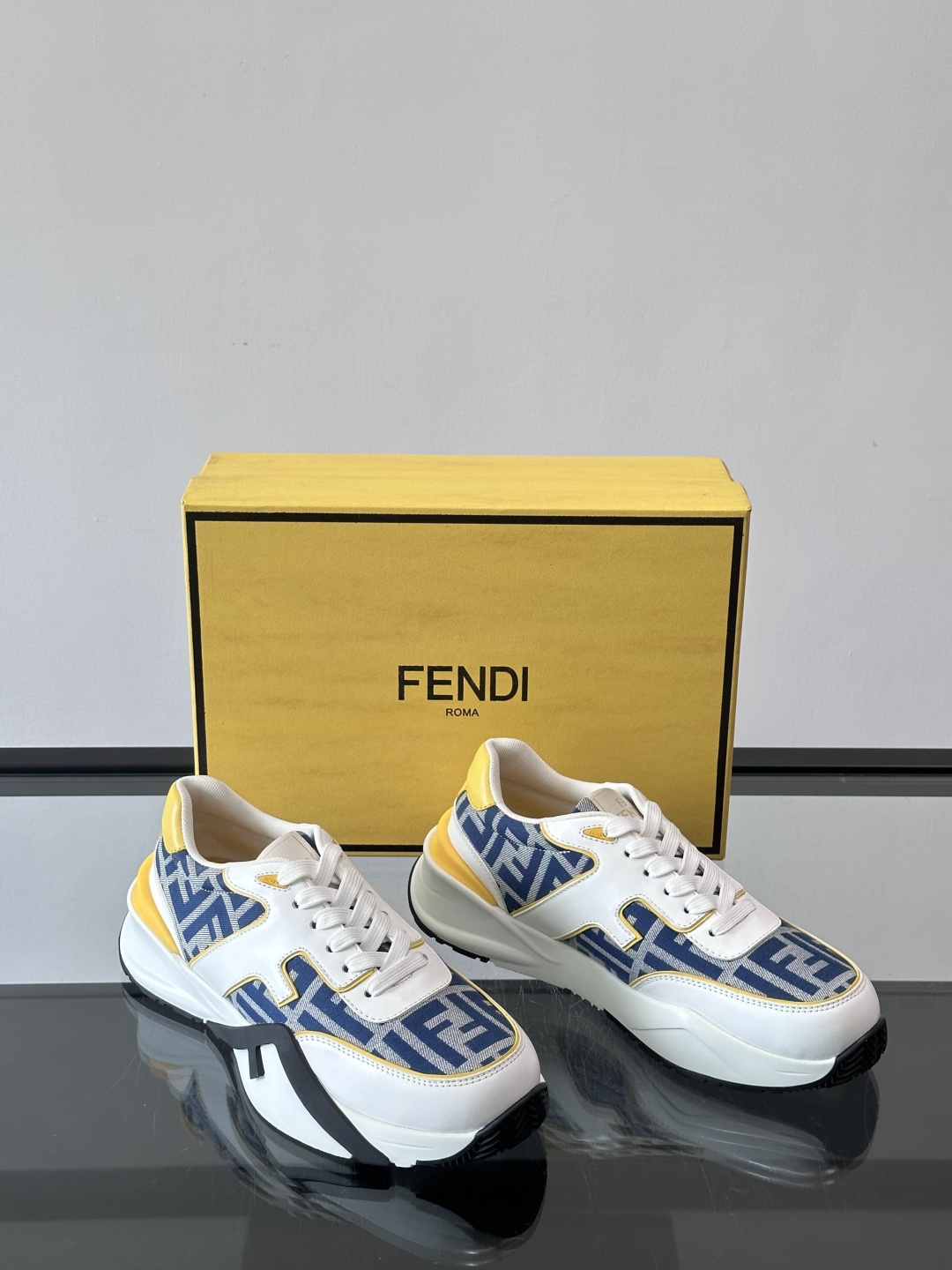 Fendi Flow sneakers in a white, black, and royal blue colorway featuring the FF motif