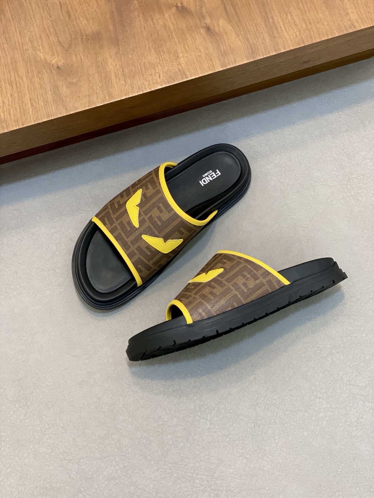 Fendi Roma slides the iconic FF logo pattern and a yellow "Bag Bugs" eye motif