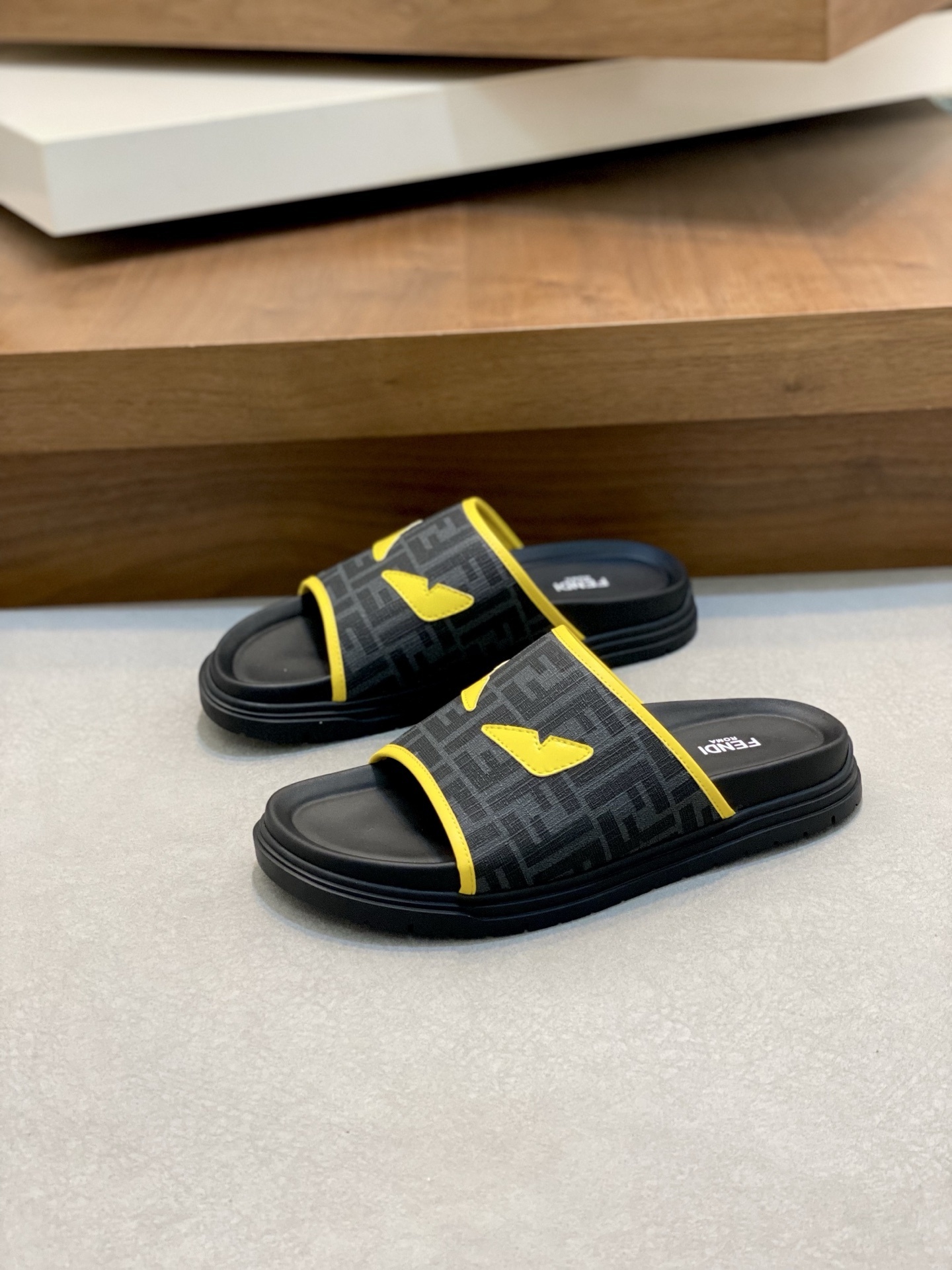 Fendi Diagonal FF jacquard sandals with a black upper, yellow trim, and rubber sole