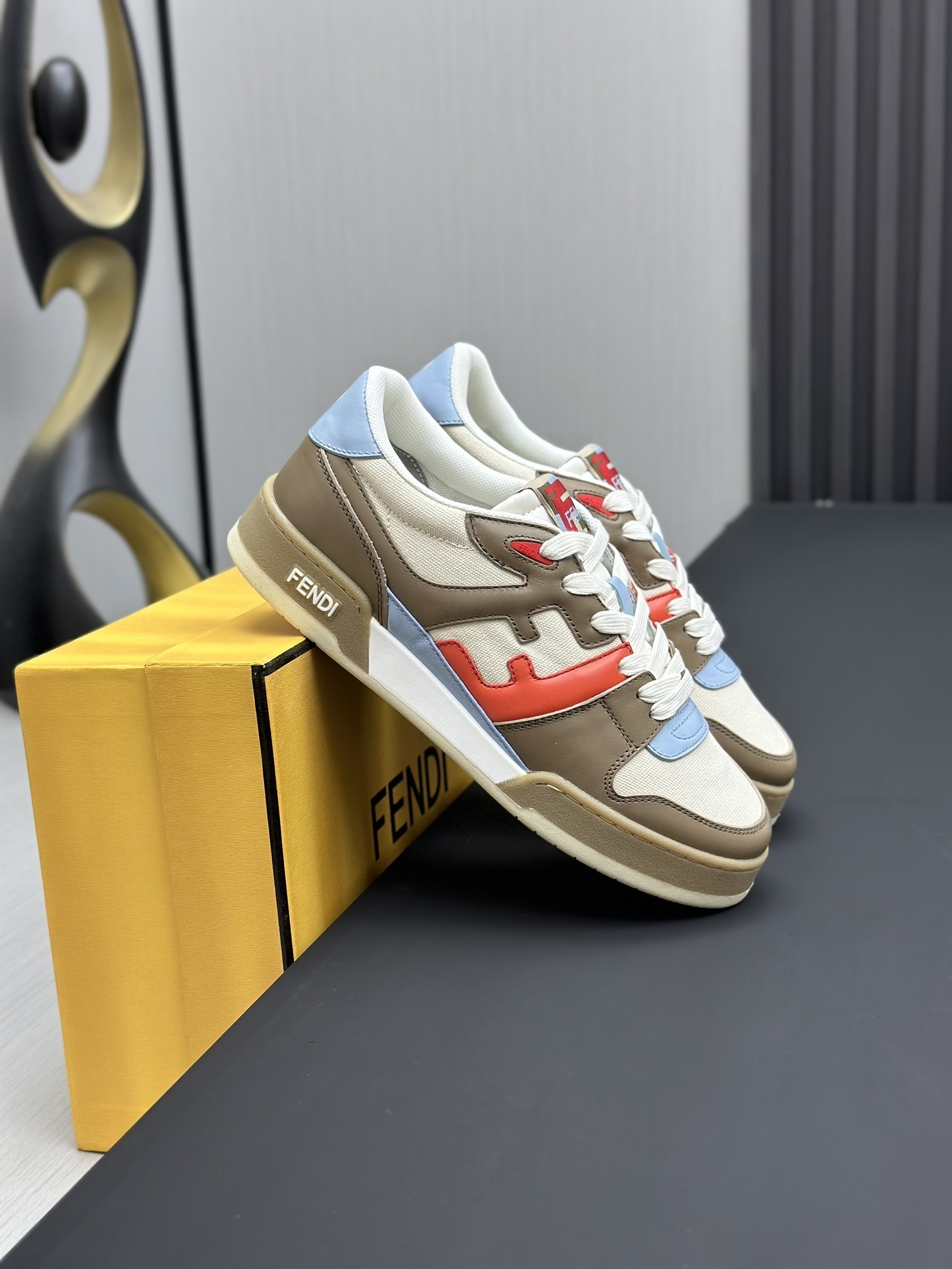 Fendi Match sneakers crafted from calf leather color-block paneled design in brown, white, red, and light blue.