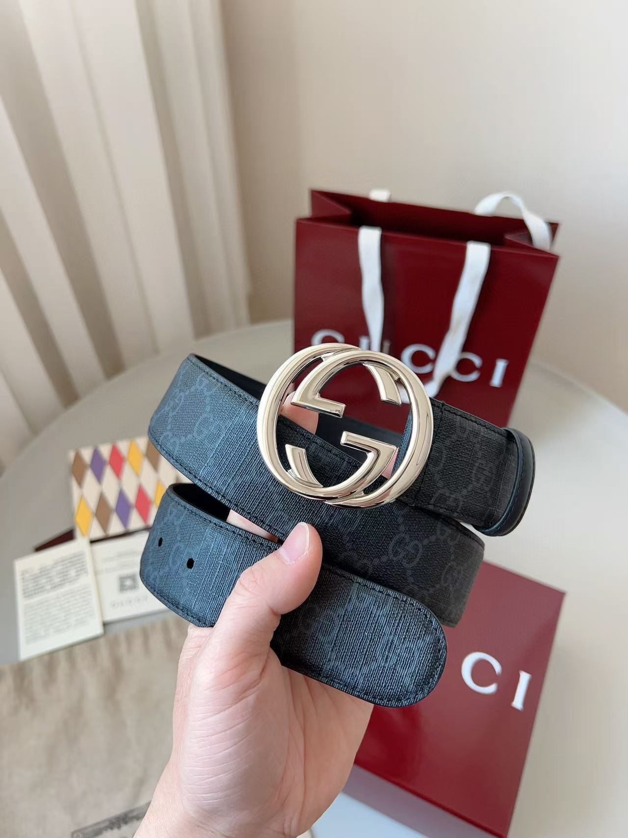 Gucci GG Supreme canvas belt with an interlocking G buckle and palladium-toned hardware