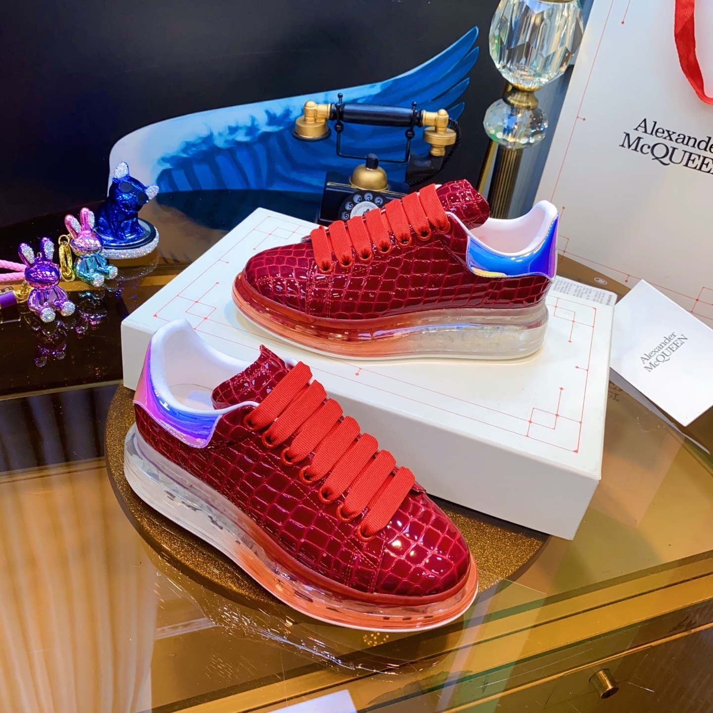 Alexander McQueen Oversized Sneaker in a red crocodile-embossed leather finish with a clear, iridescent sole
