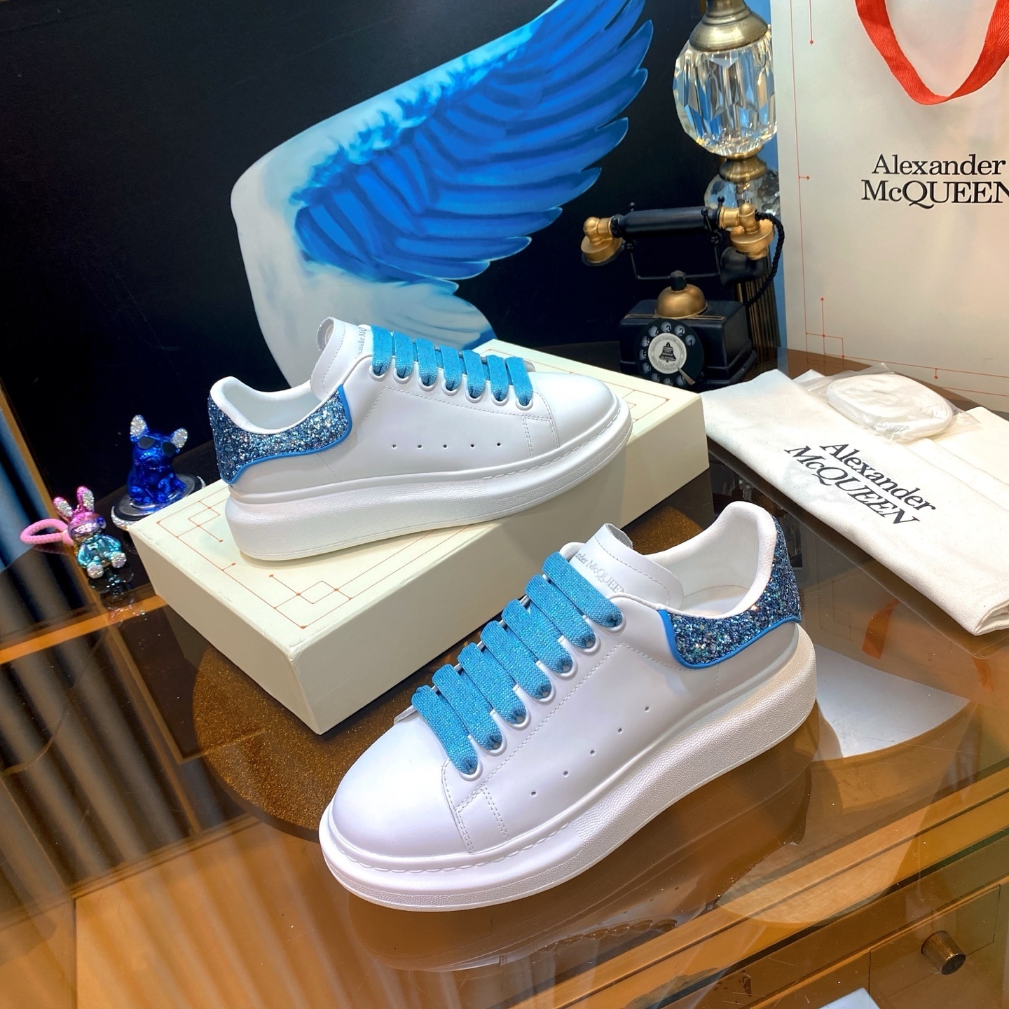 Alexander McQueen Oversized Sneakers in white with a crystal-embellished electric blue heel tab and matching blue laces