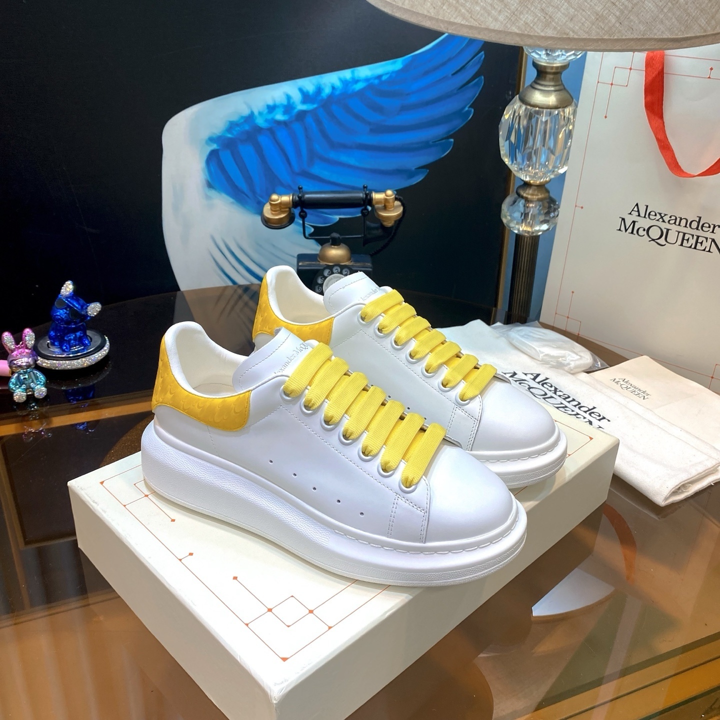 Alexander McQueen Oversized Sneakers in white leather with a yellow suede heel tab and yellow laces