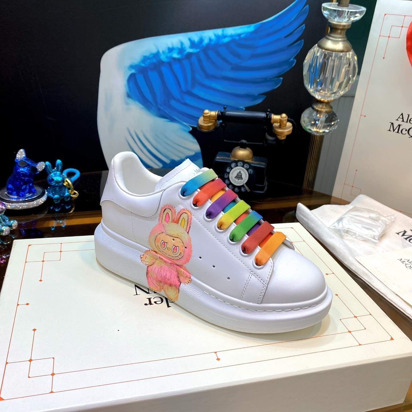 Alexander McQueen oversized sneakers customized with a Labubu character graphic and rainbow laces