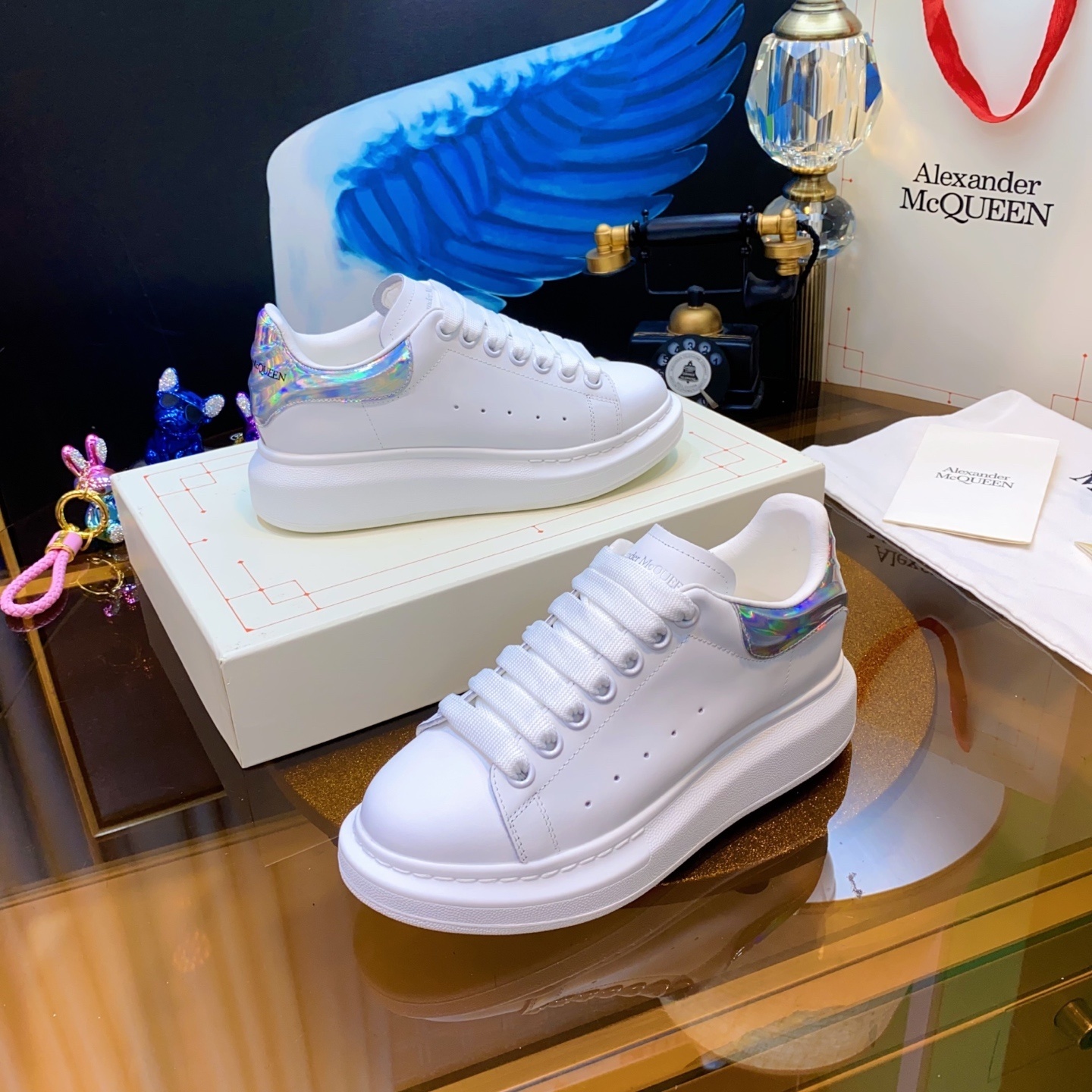 Alexander McQueen Oversized Sneaker with a white leather upper and iridescent/holographic heel tab