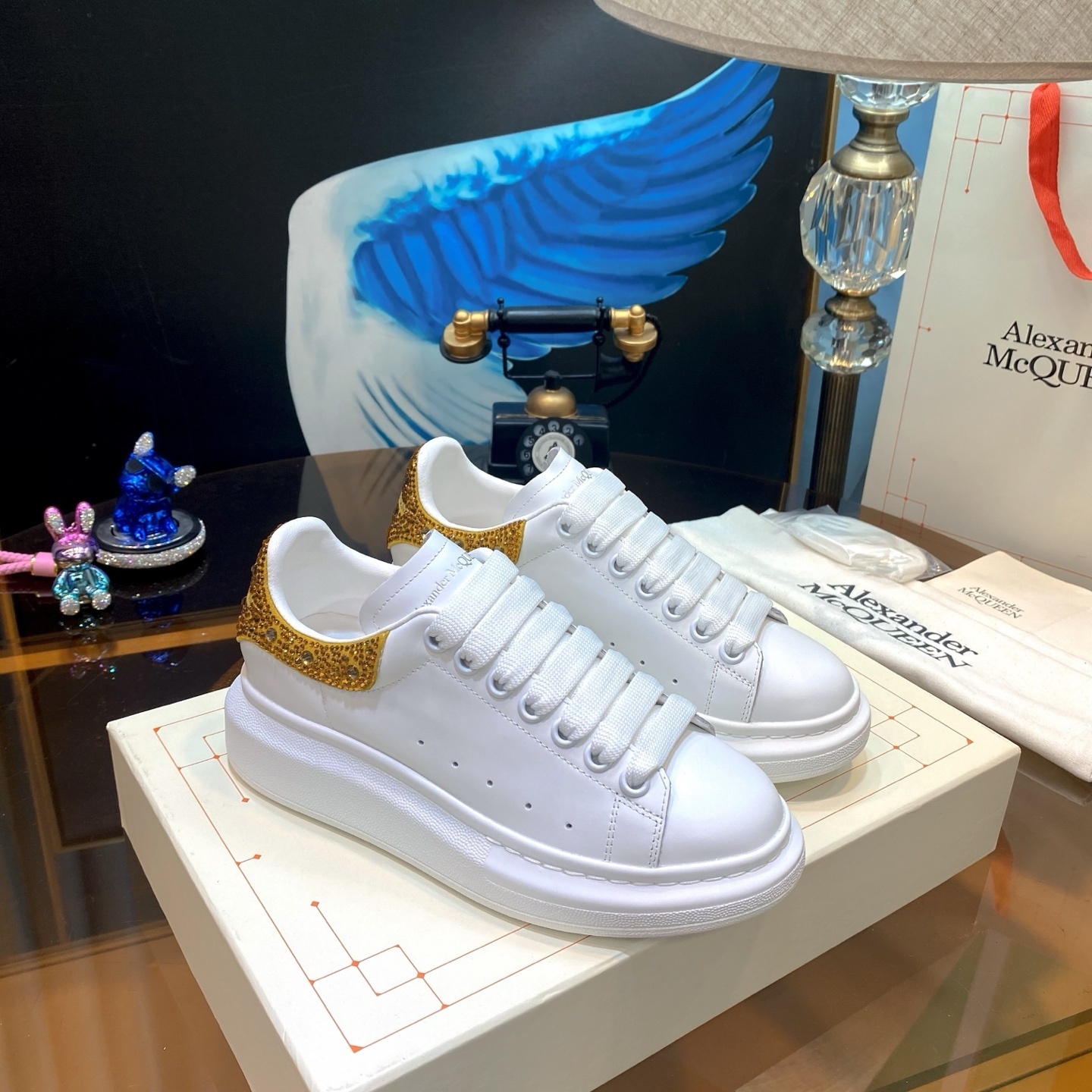 Alexander McQueen Oversized Sneaker in white calf leather with a gold glitter or crystal-embellished heel counter