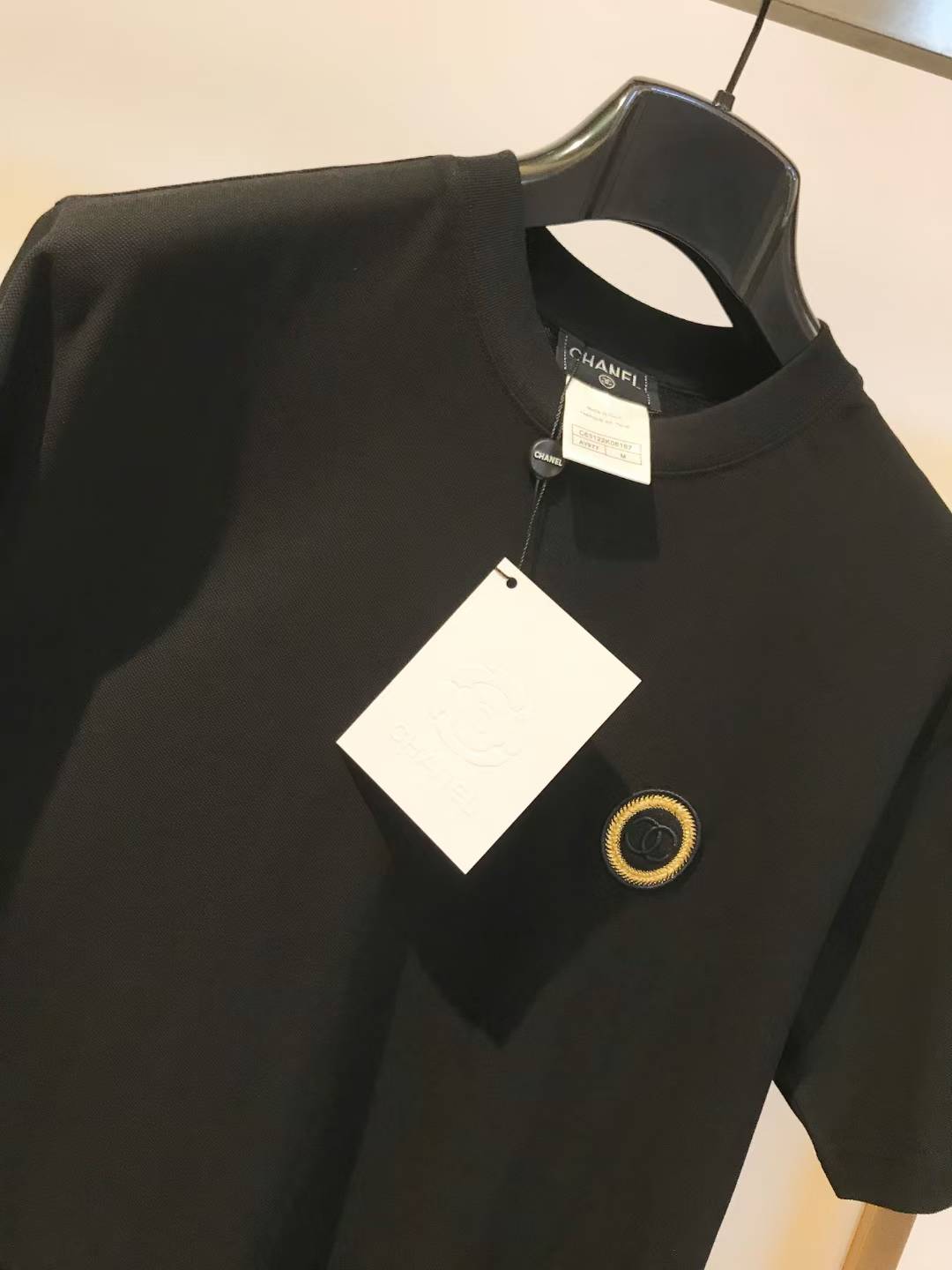 Chanel top with a gold-tone emblem