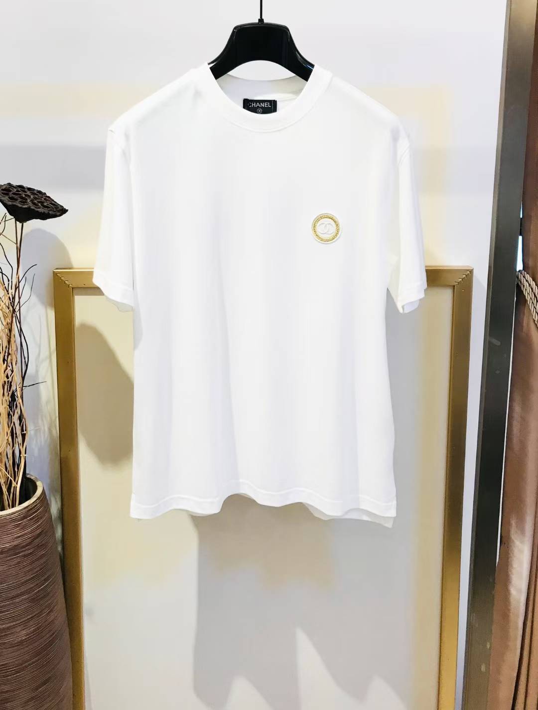Chanel Jeans Couture white cotton t-shirt with a gold logo emblem.