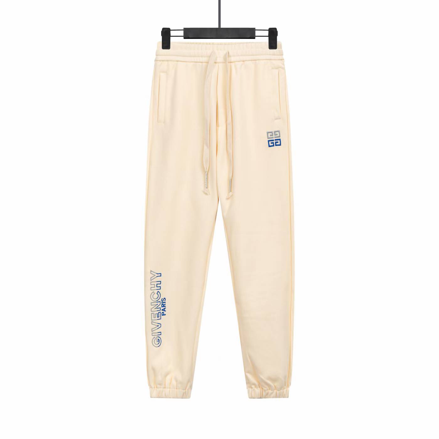 Givenchy sweatpants in a cream color with blue logo