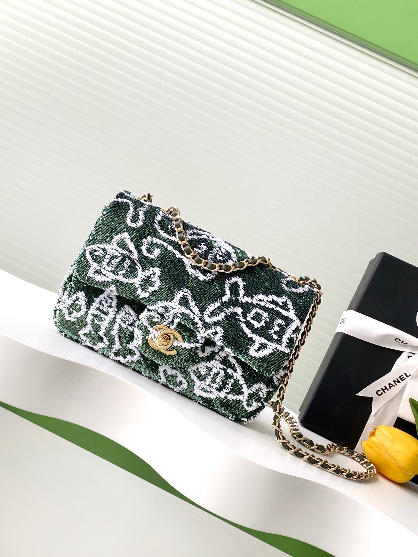 Chanel Flap Bag in green velvet with white embroidery and gold-tone hardware.