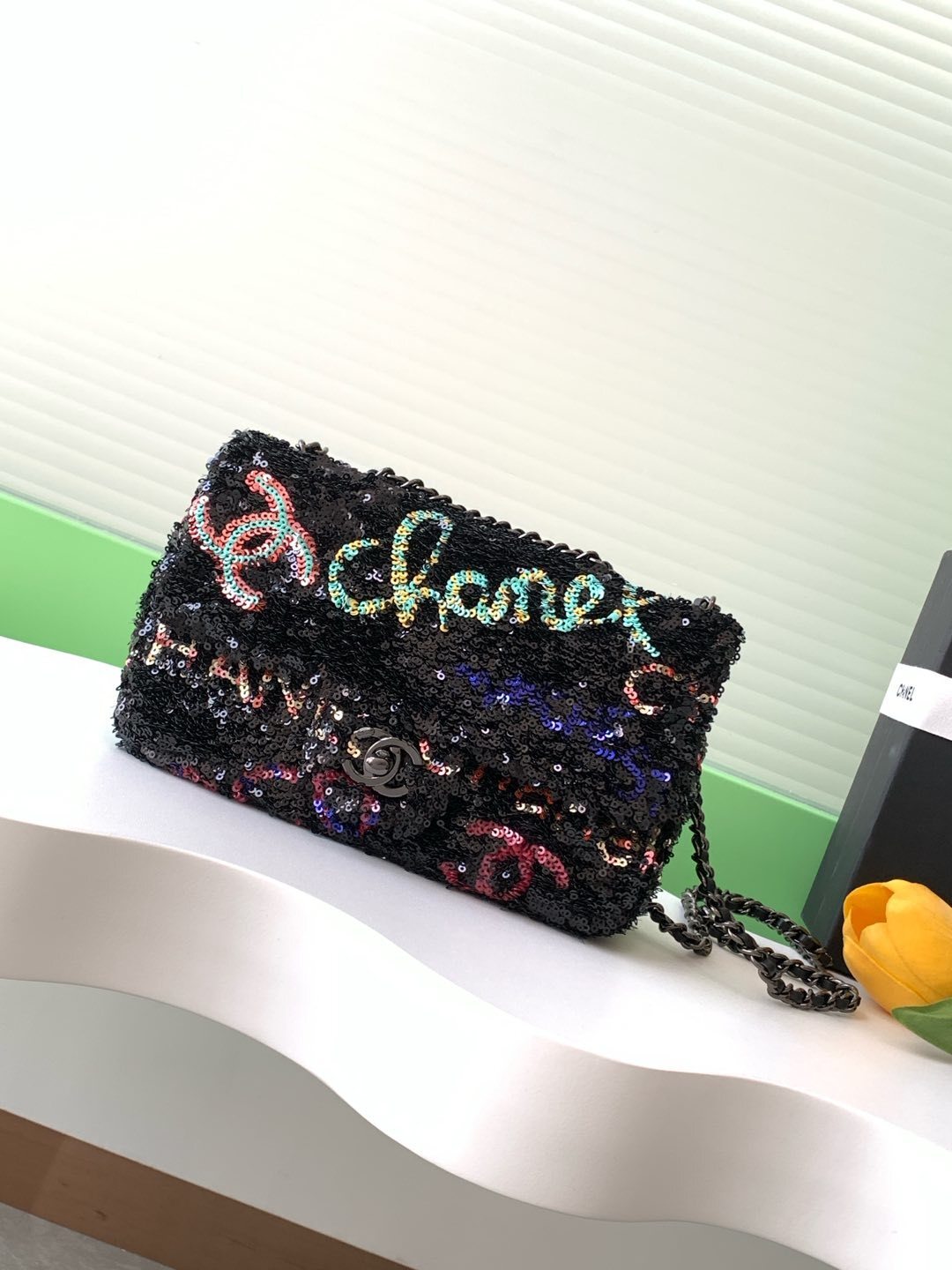 Chanel Logo CC small single flap bag in black with multicoloured sequins.