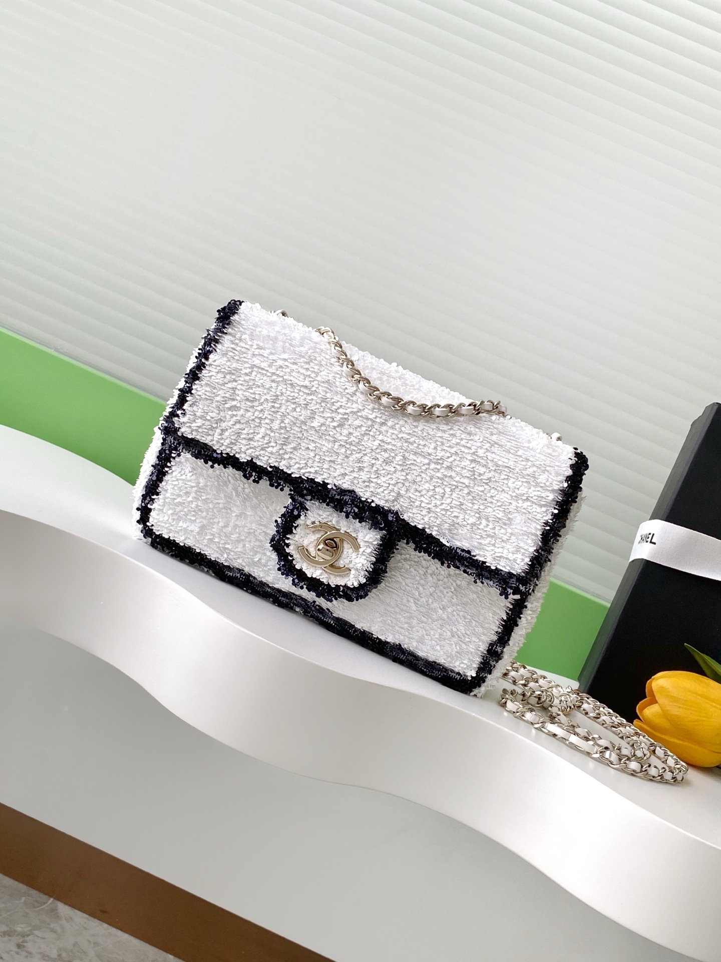 Chanel AS4561 Flap Bag in white quilted sequins with black trim and gold-tone metal hardware